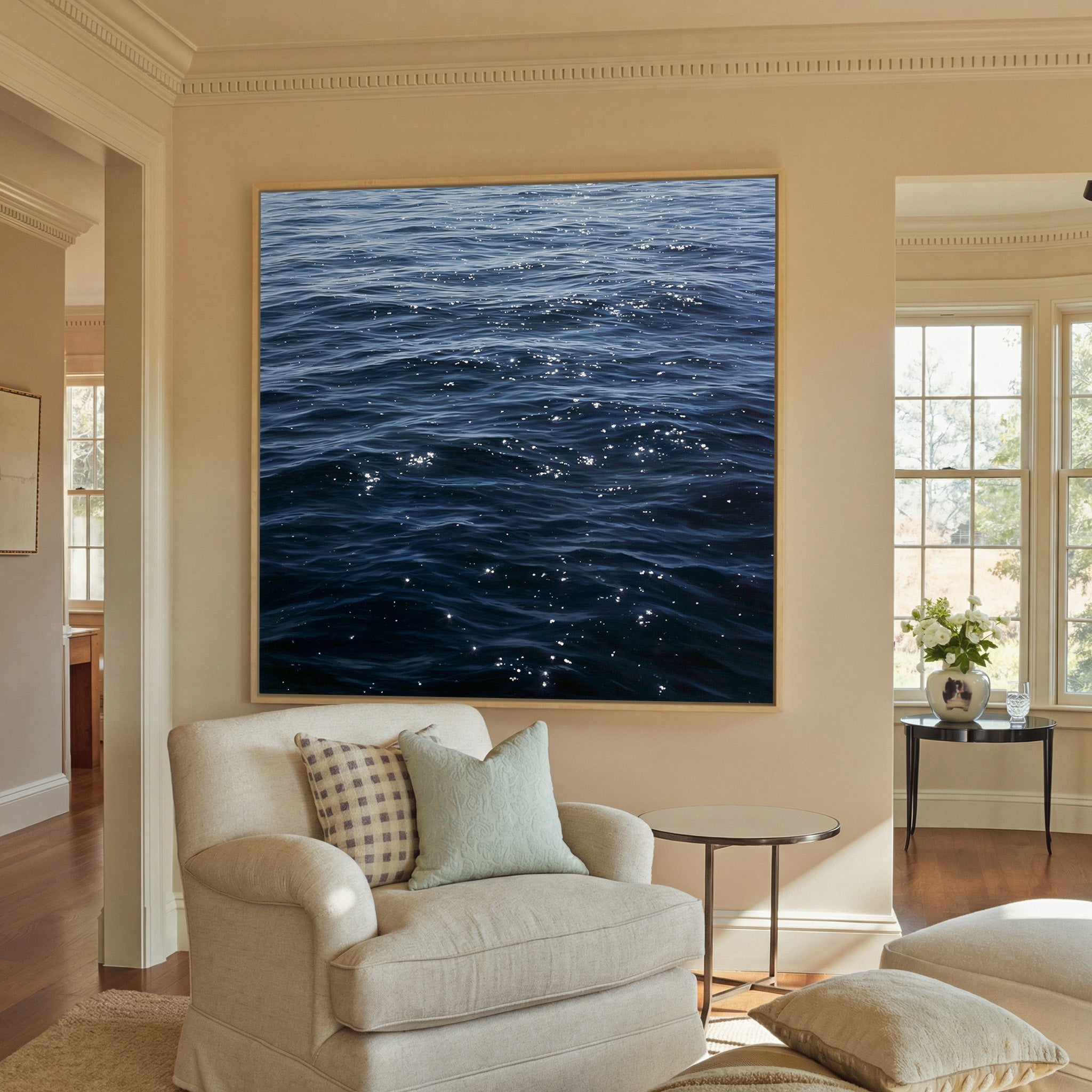 dark blue water with scattered canvas wall art in a natural wood frame in a styled room setting