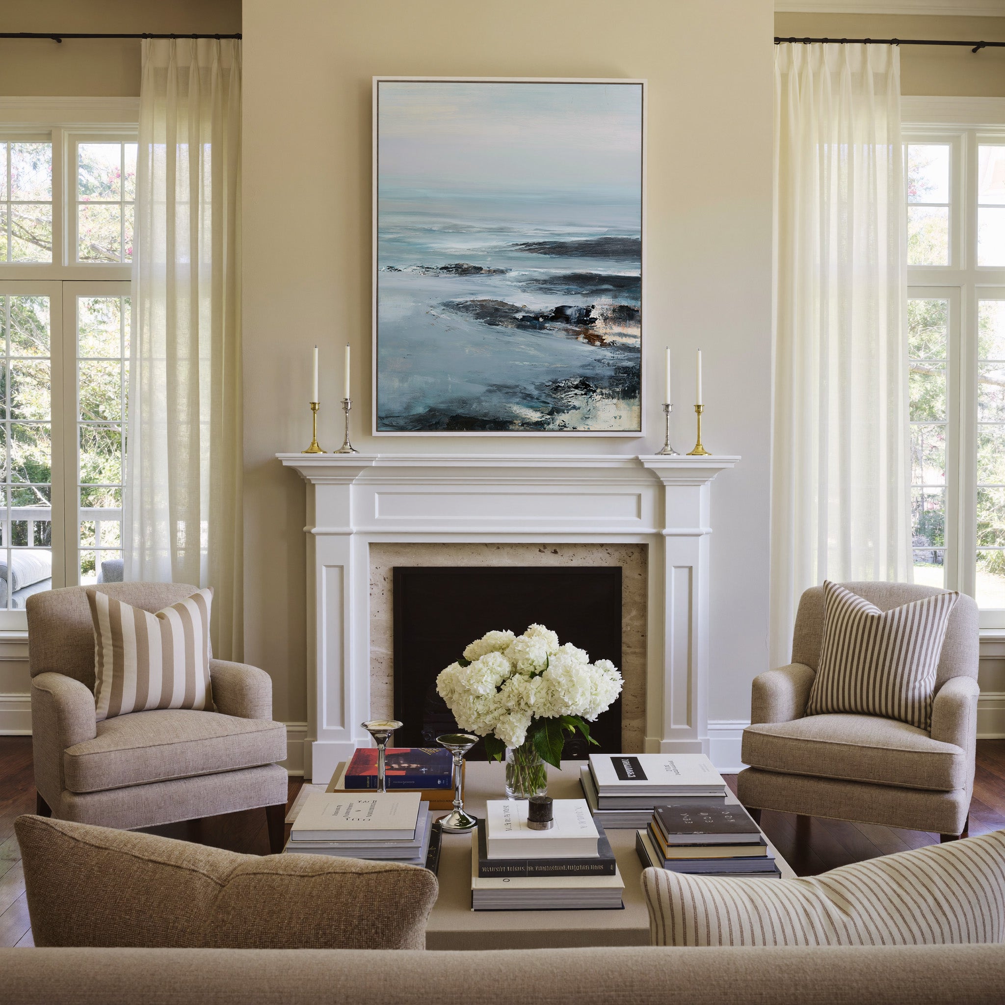 cold northern sea with pale sky and dark rock canvas wall art in a white frame above a mantel