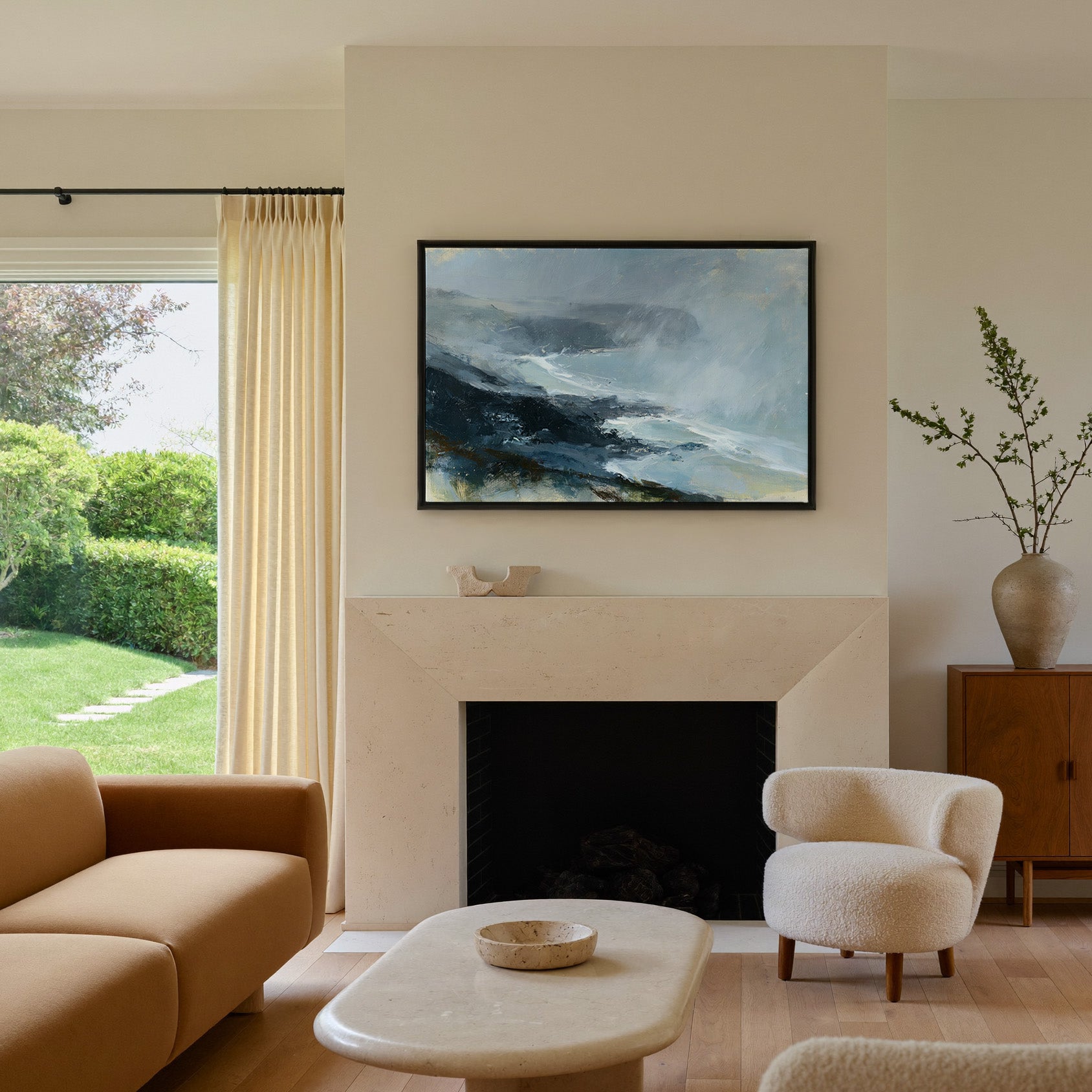 windswept coastal headland in rain and mist canvas wall art in a black frame above a mantel