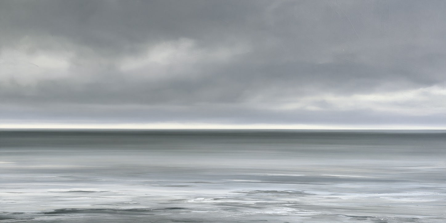 Nearly monochrome sea with a smoke grey sky and thin white light at the horizon