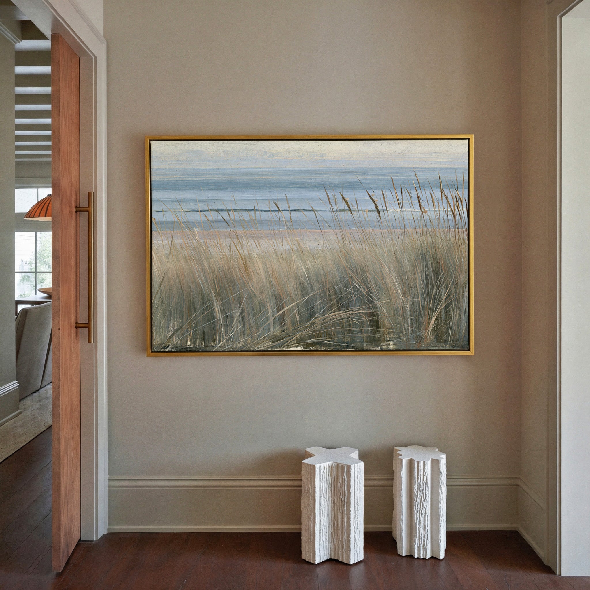 beach grass with blue water and pale dune bands canvas wall art in a gold frame in a styled room setting