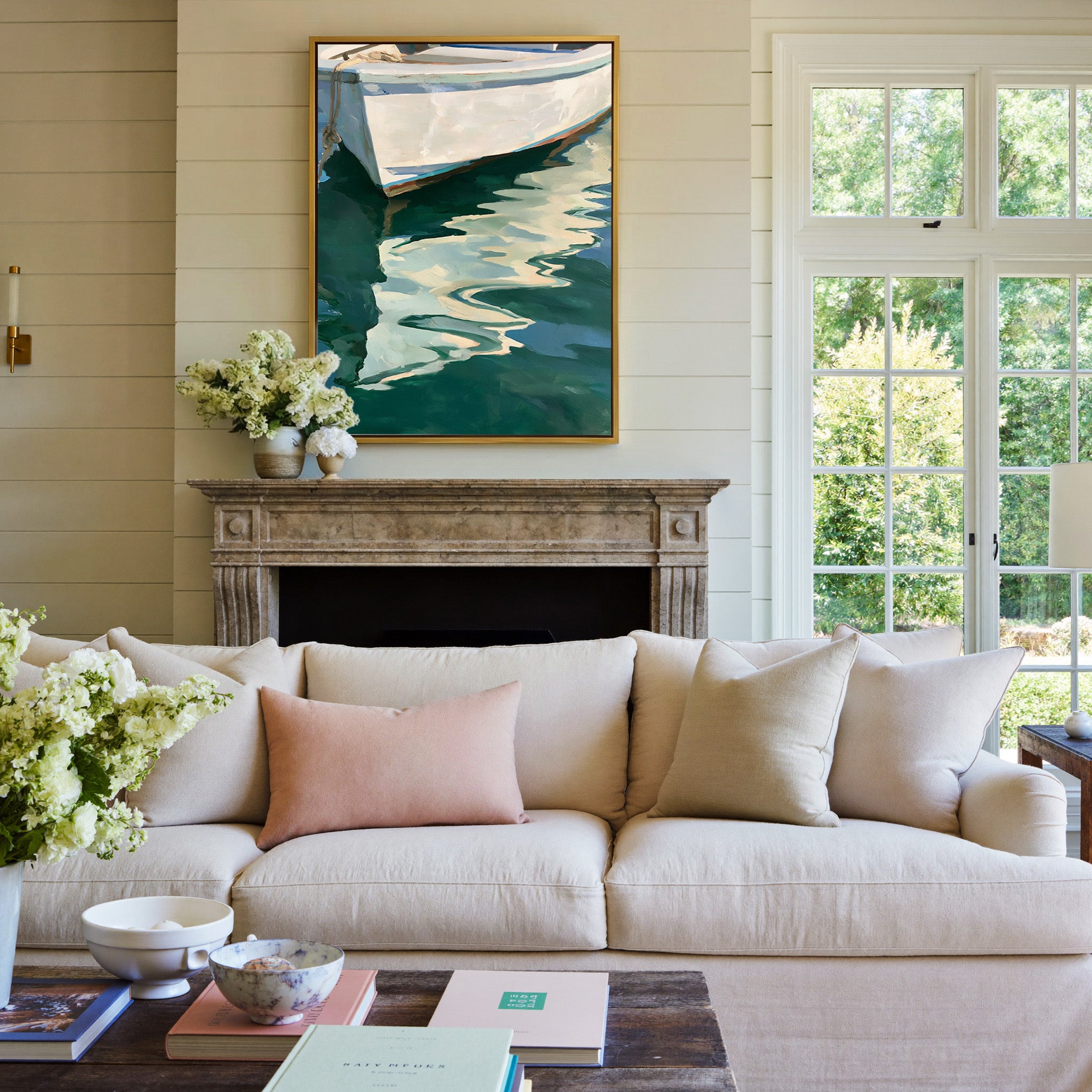 white boat hull over deep green water canvas wall art in a gold frame above a mantel