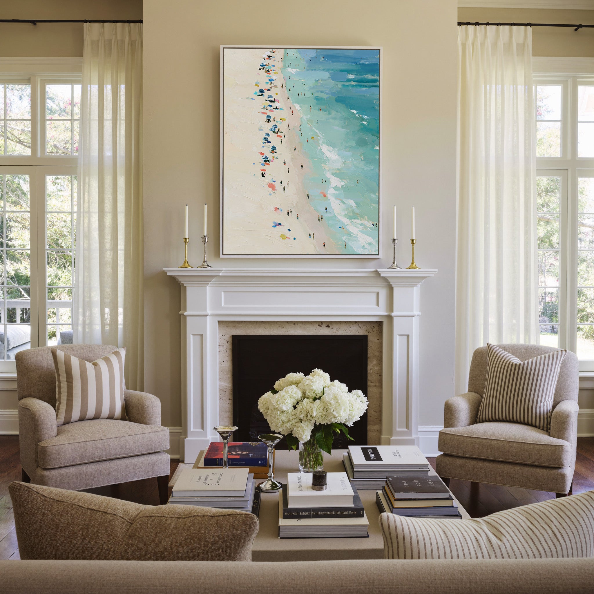 sunlit beach with turquoise water and scattered canvas wall art in a white frame above a mantel