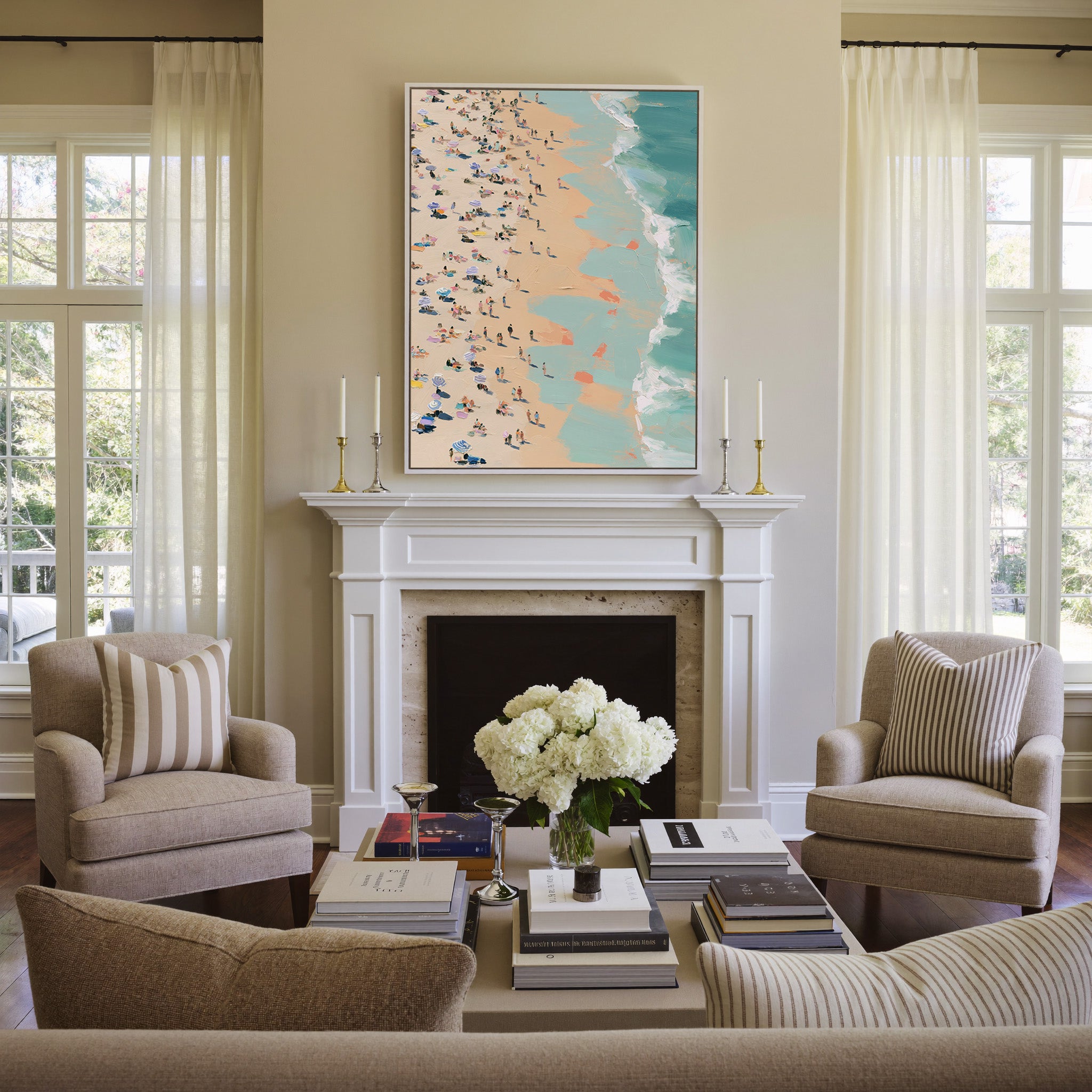 sunlit beach with turquoise surf and scattered canvas wall art in a white frame above a mantel