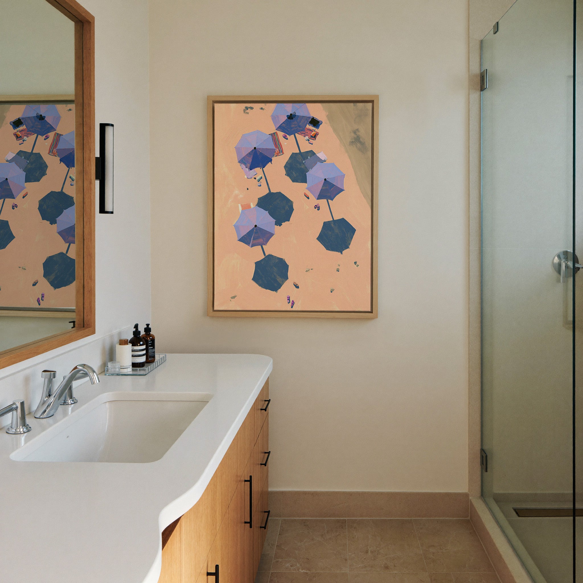 overhead beach umbrellas on peach sand canvas wall art in a natural wood frame in a styled room setting