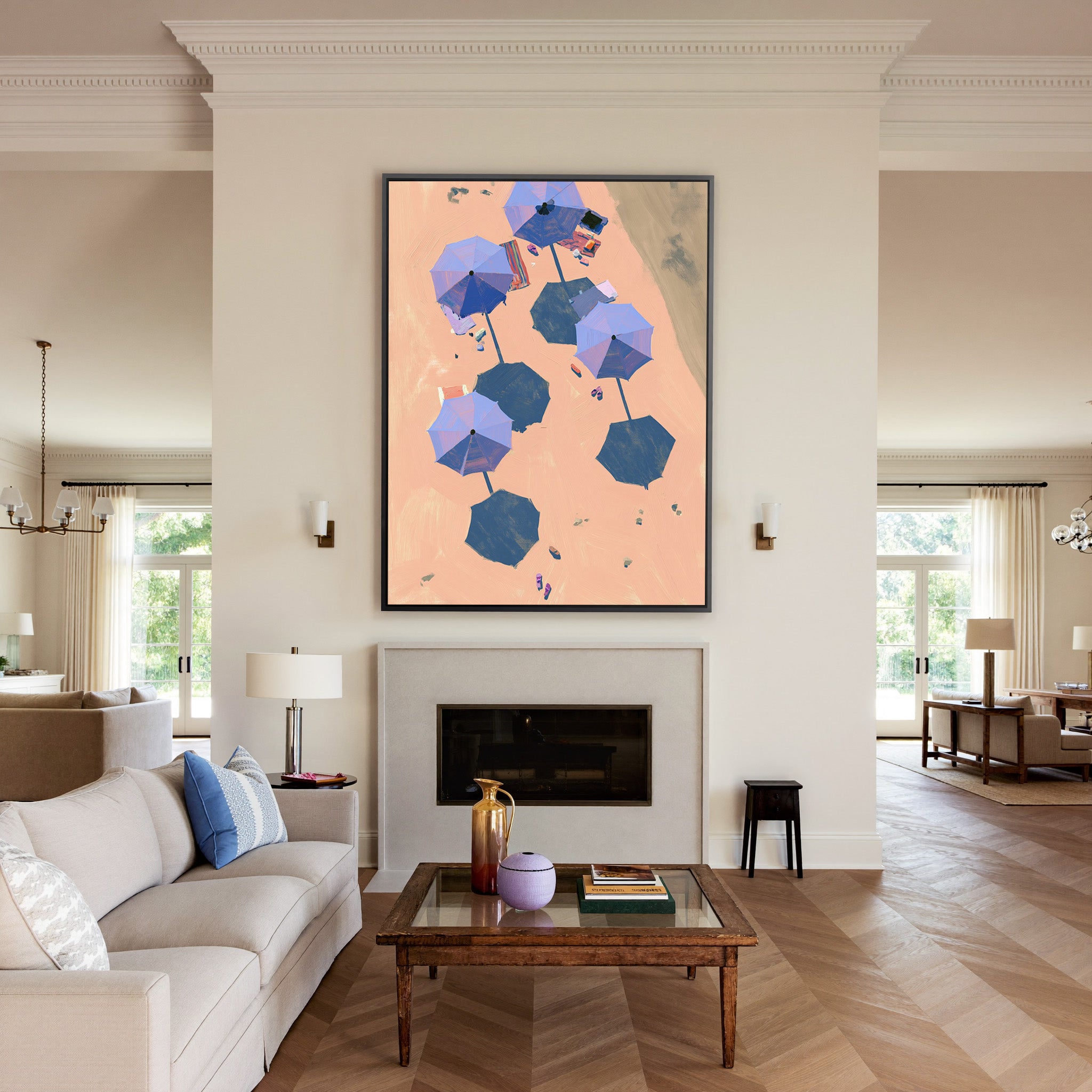 overhead beach umbrellas on peach sand canvas wall art in a black frame above a mantel