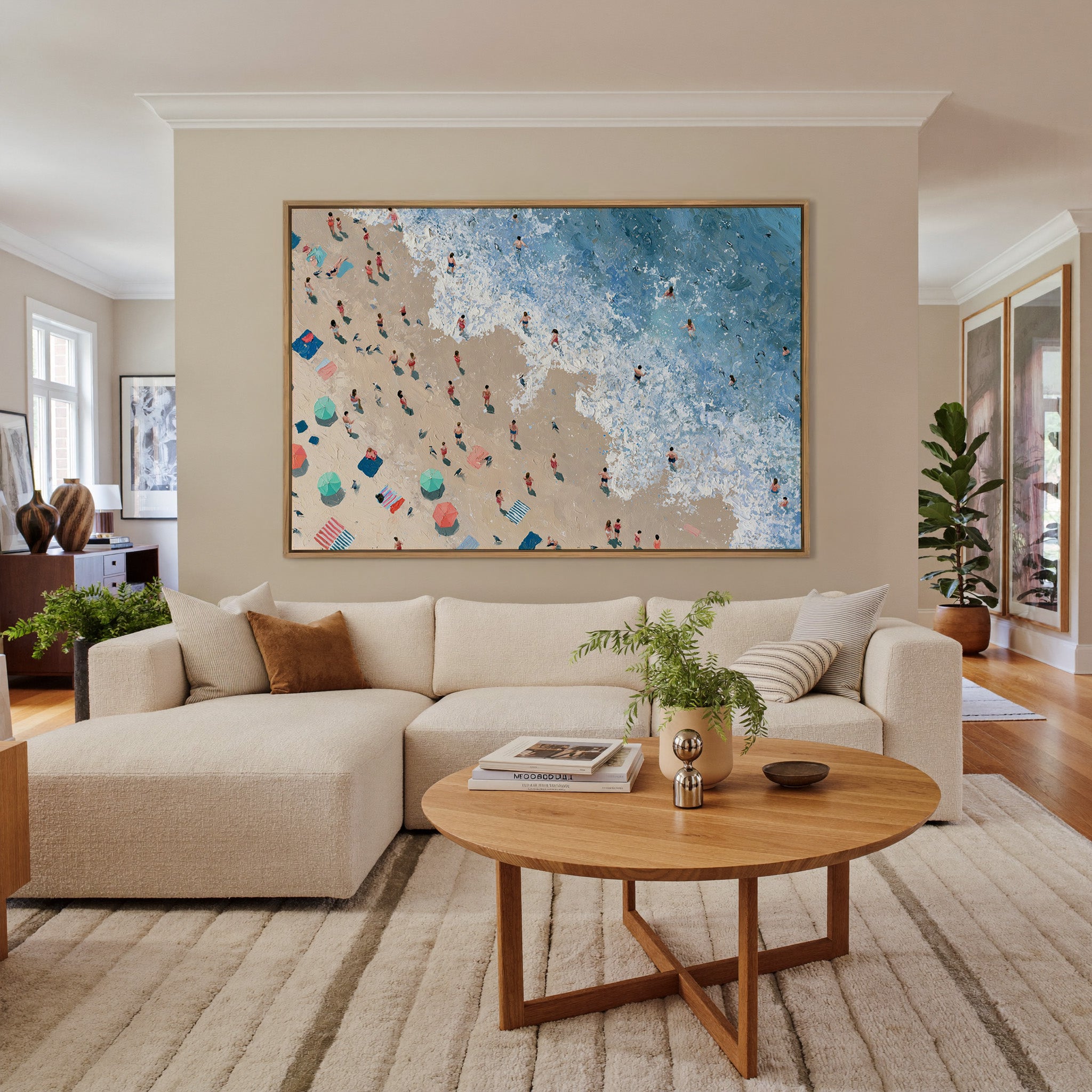 diagonal shoreline with swimmers and umbrellas canvas wall art in an oak frame in a living room