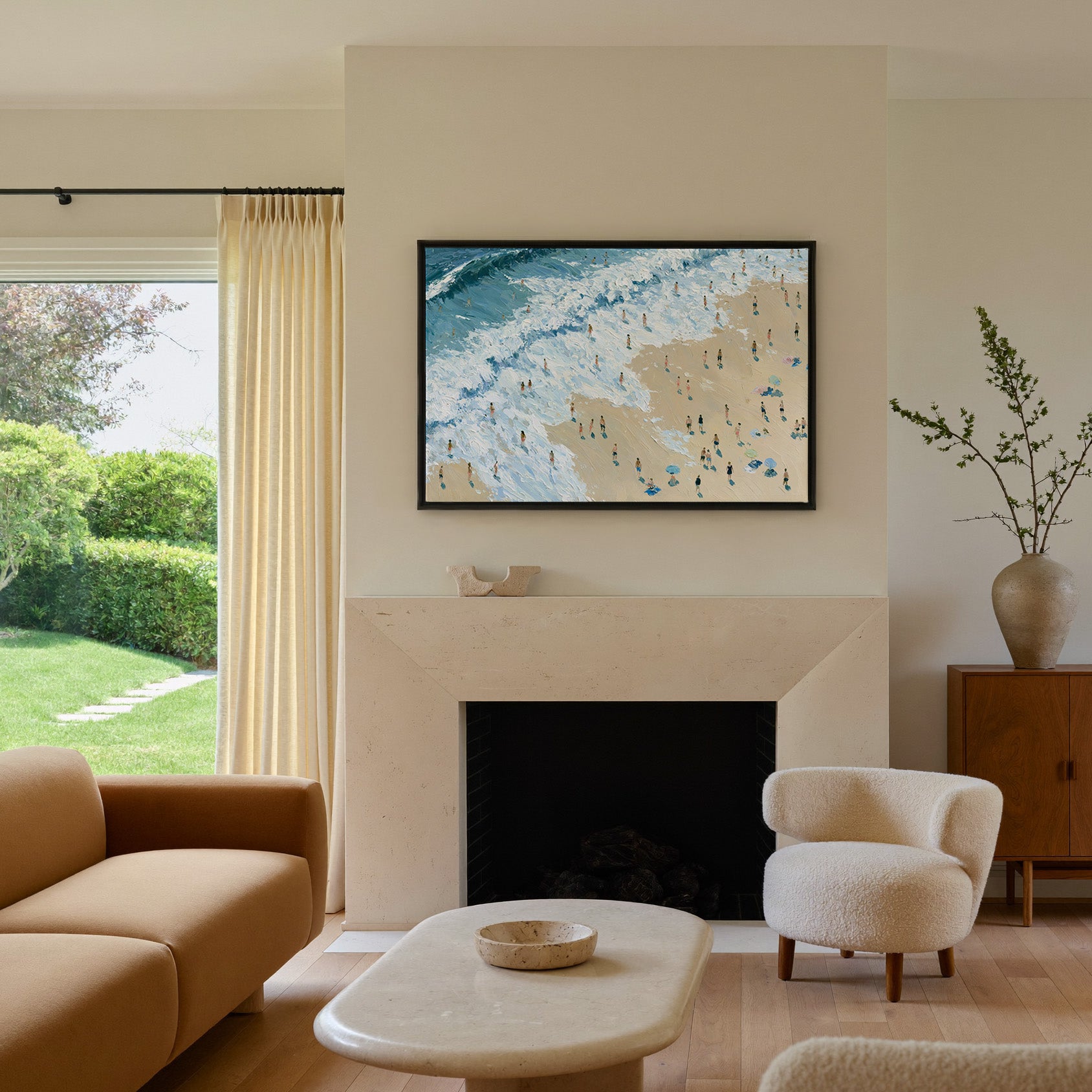 diagonal shoreline with white surf and small canvas wall art in a black frame above a mantel