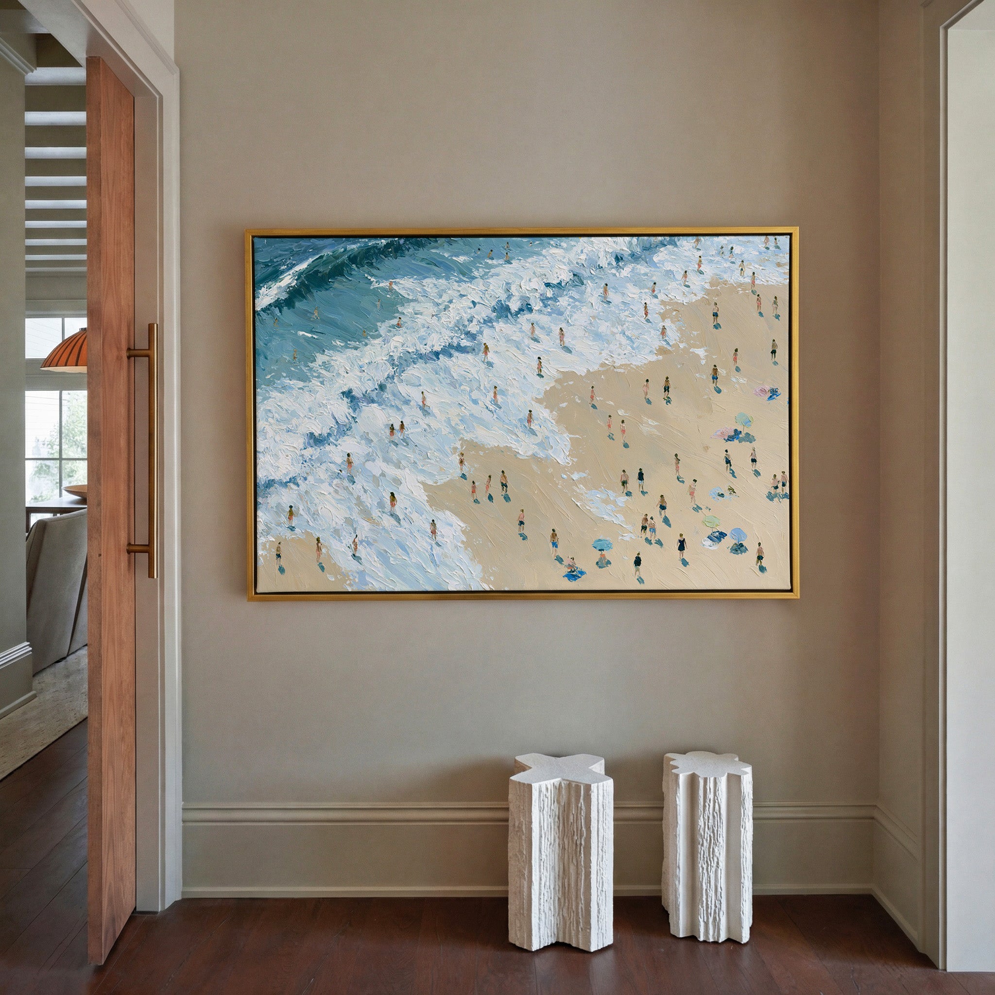 diagonal shoreline with white surf and small canvas wall art in a gold frame in a styled room setting