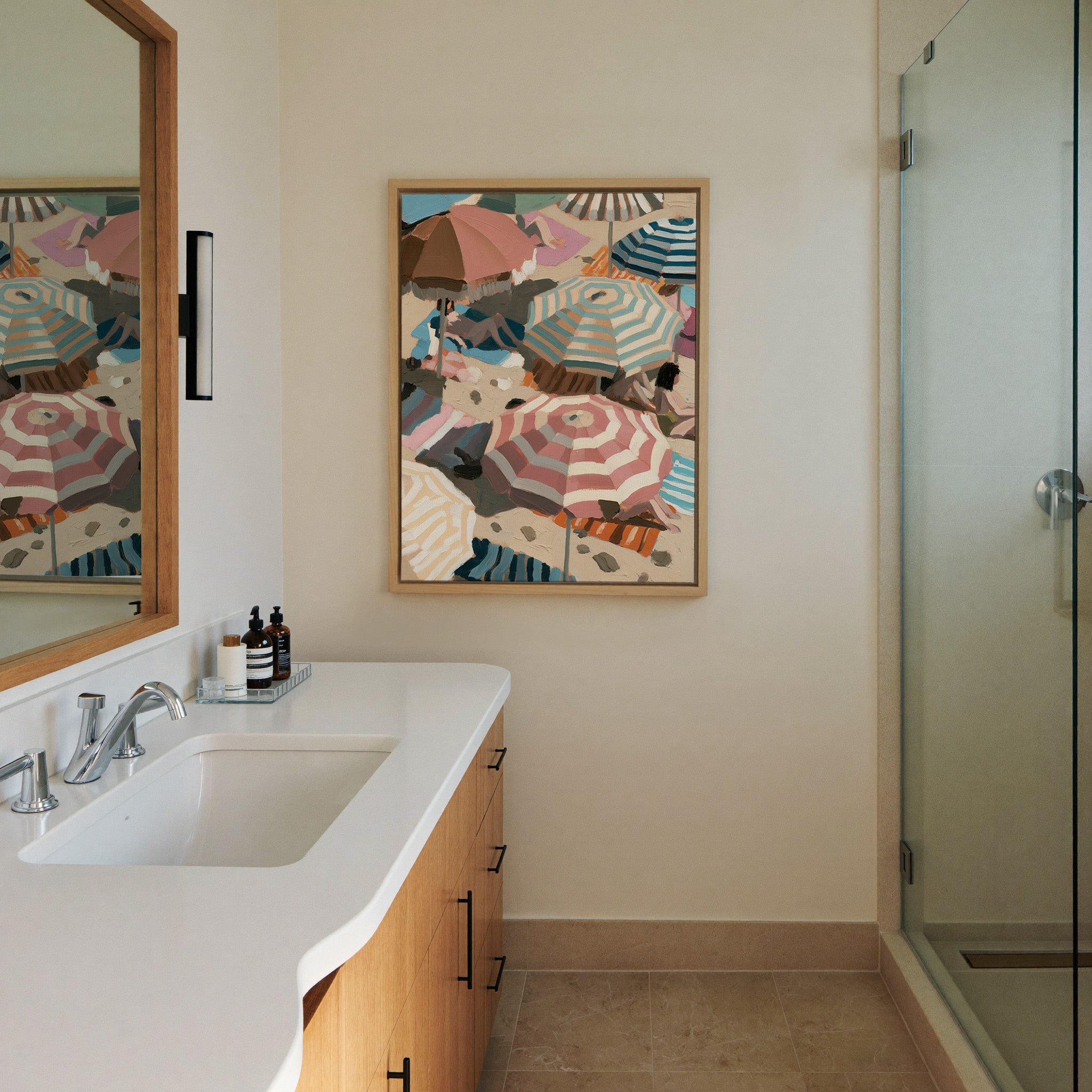 overlapping beach umbrellas in striped pink, canvas wall art in a natural wood frame in a styled room setting