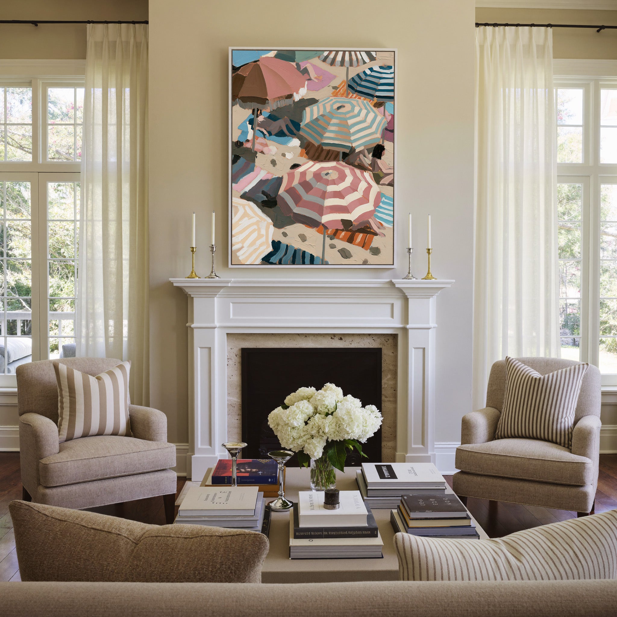 overlapping beach umbrellas in striped pink, canvas wall art in a white frame above a mantel