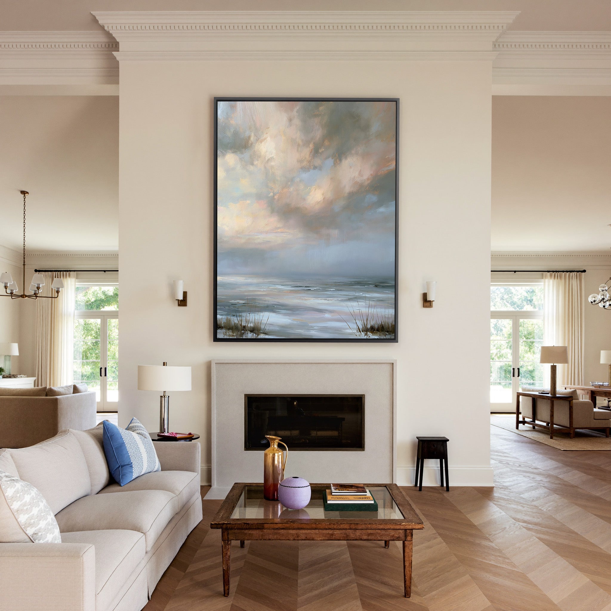pale coastal horizon beneath broken clouds canvas wall art in a black frame above a mantel