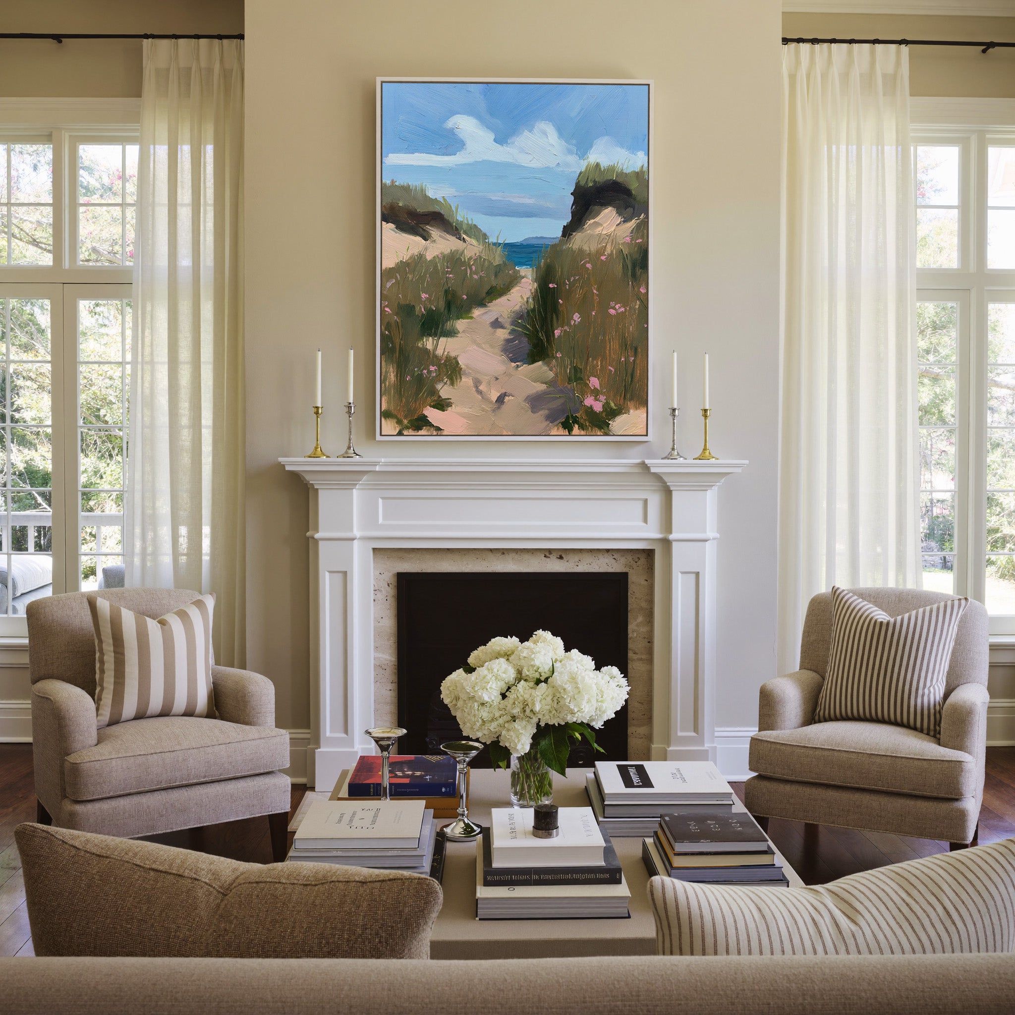 windswept coastal path with dune grass and pink canvas wall art in a white frame above a mantel