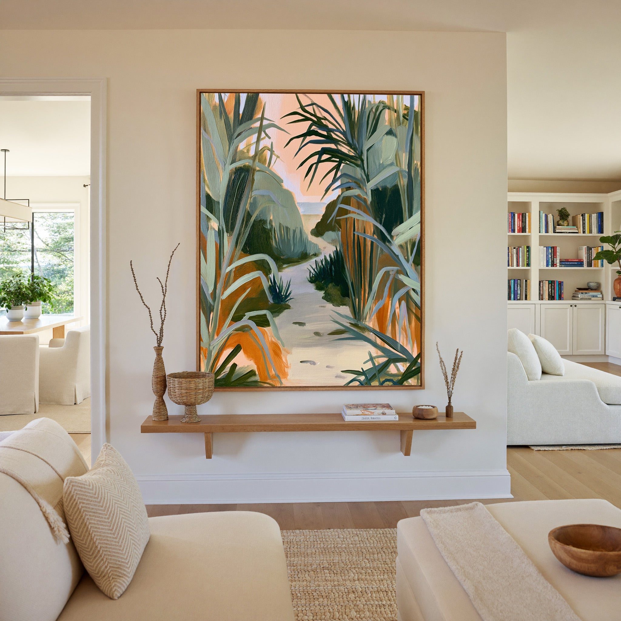 sandy path between tall coastal grasses canvas wall art in an oak frame in a living room