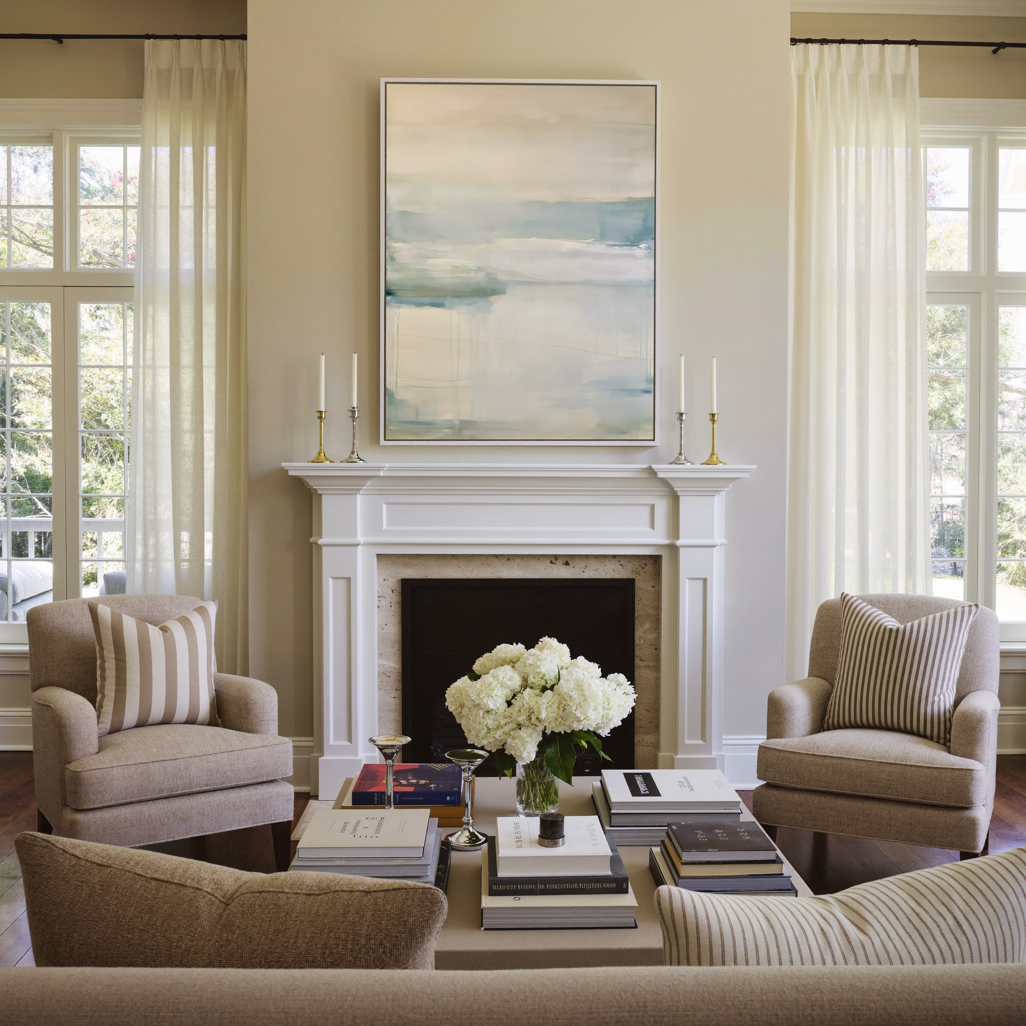 soft cream and blue abstract with misty canvas wall art in a white frame above a mantel