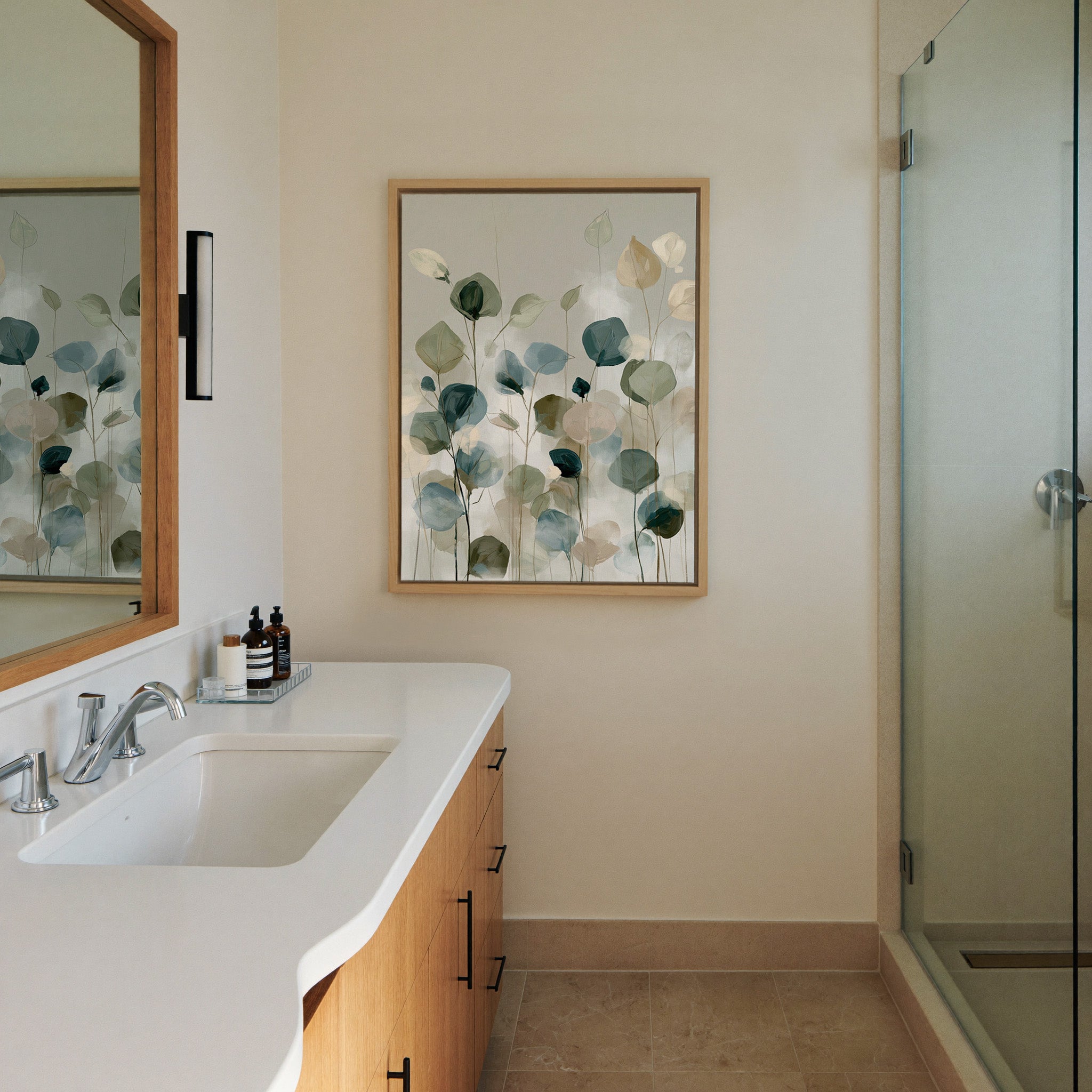 soft eucalyptus like leaves in muted green, canvas wall art in a natural wood frame in a styled room setting