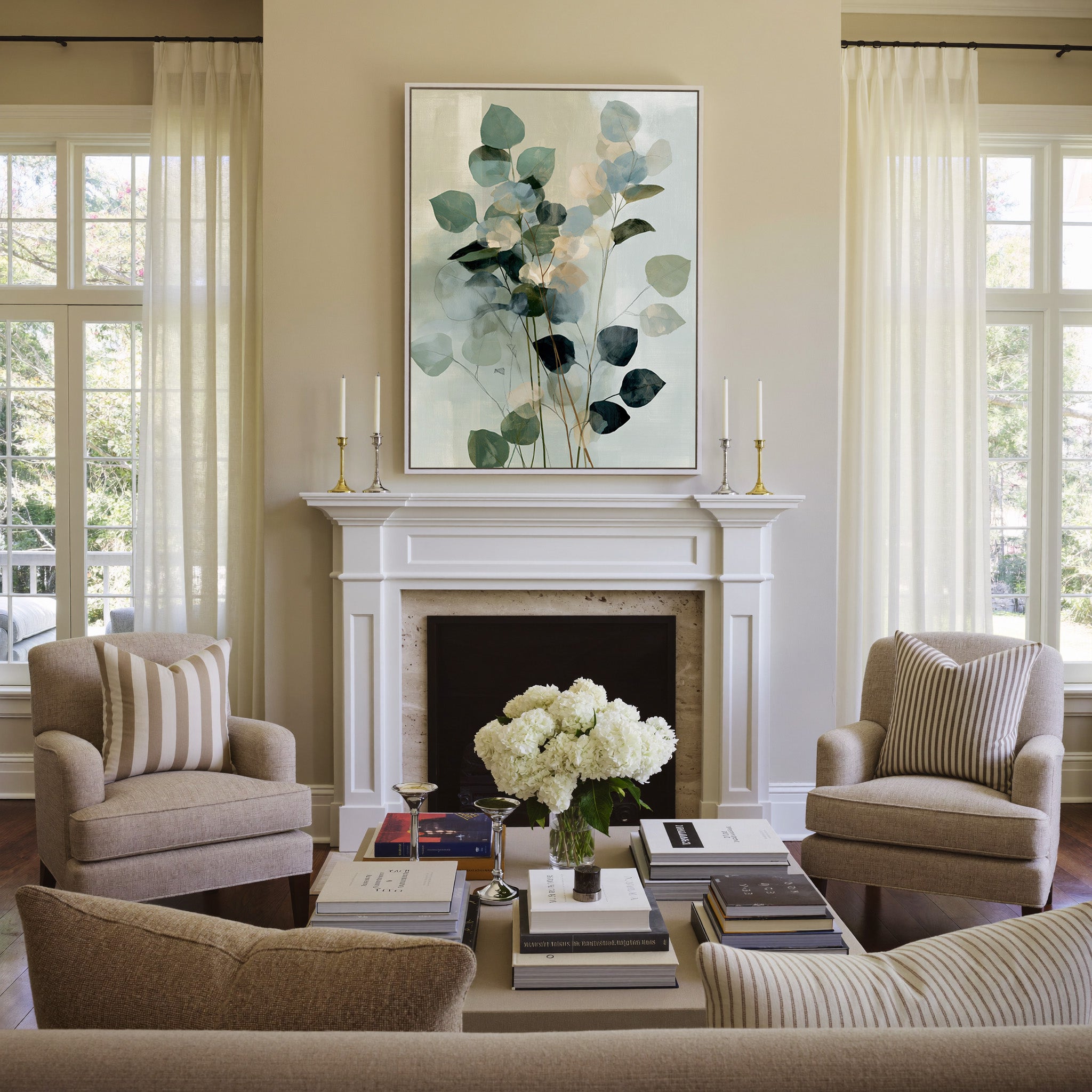 soft eucalyptus like leaves in blue green and canvas wall art in a white frame above a mantel
