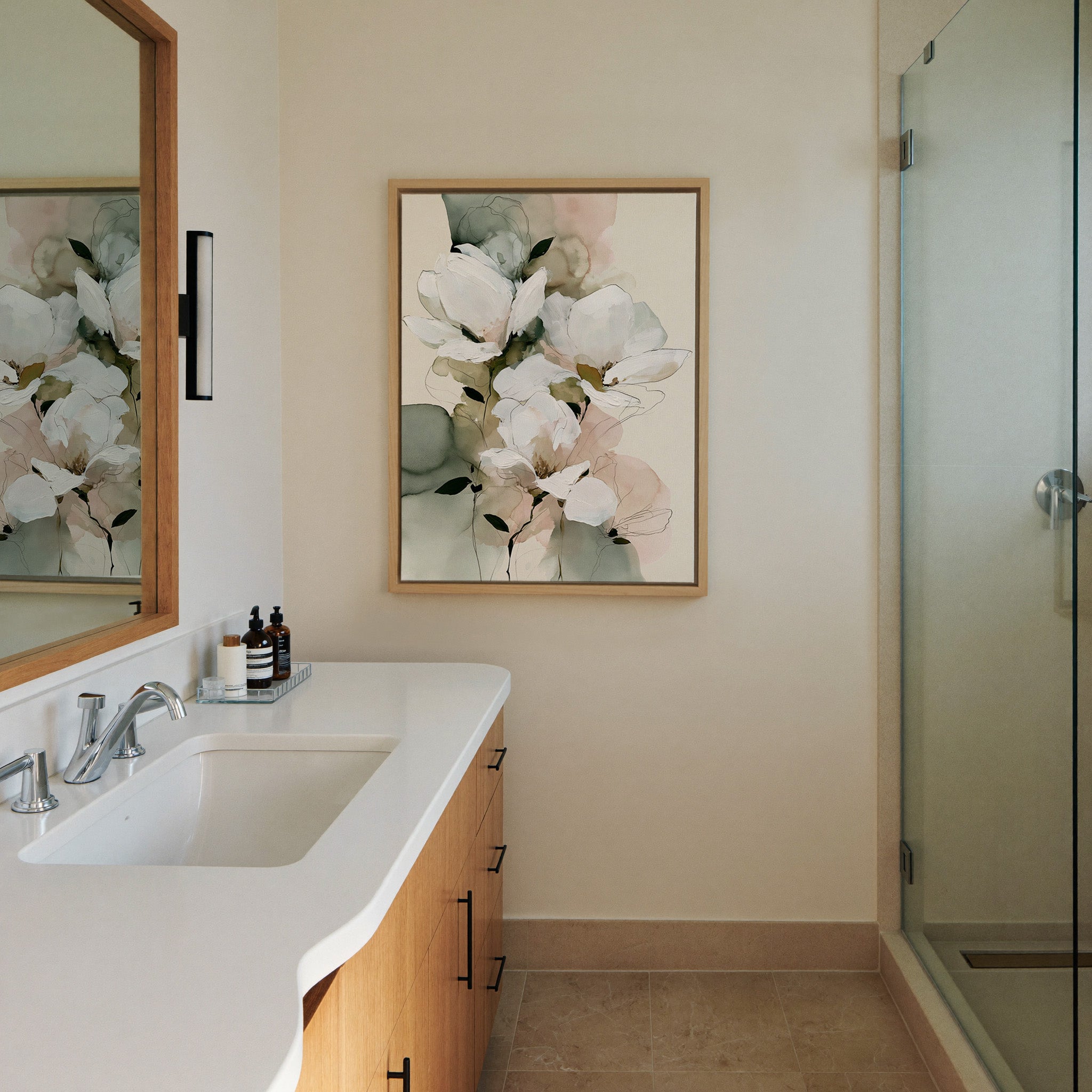 white magnolia like blooms with canvas wall art in a natural wood frame in a styled room setting