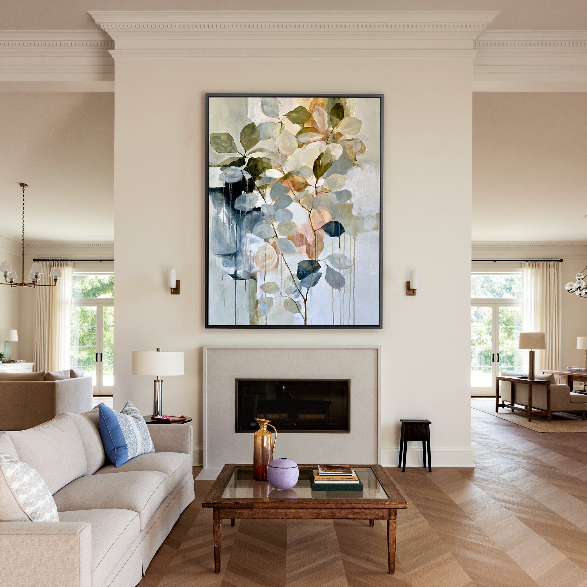 soft eucalyptus like leaves in cream, sage, canvas wall art in a black frame above a mantel