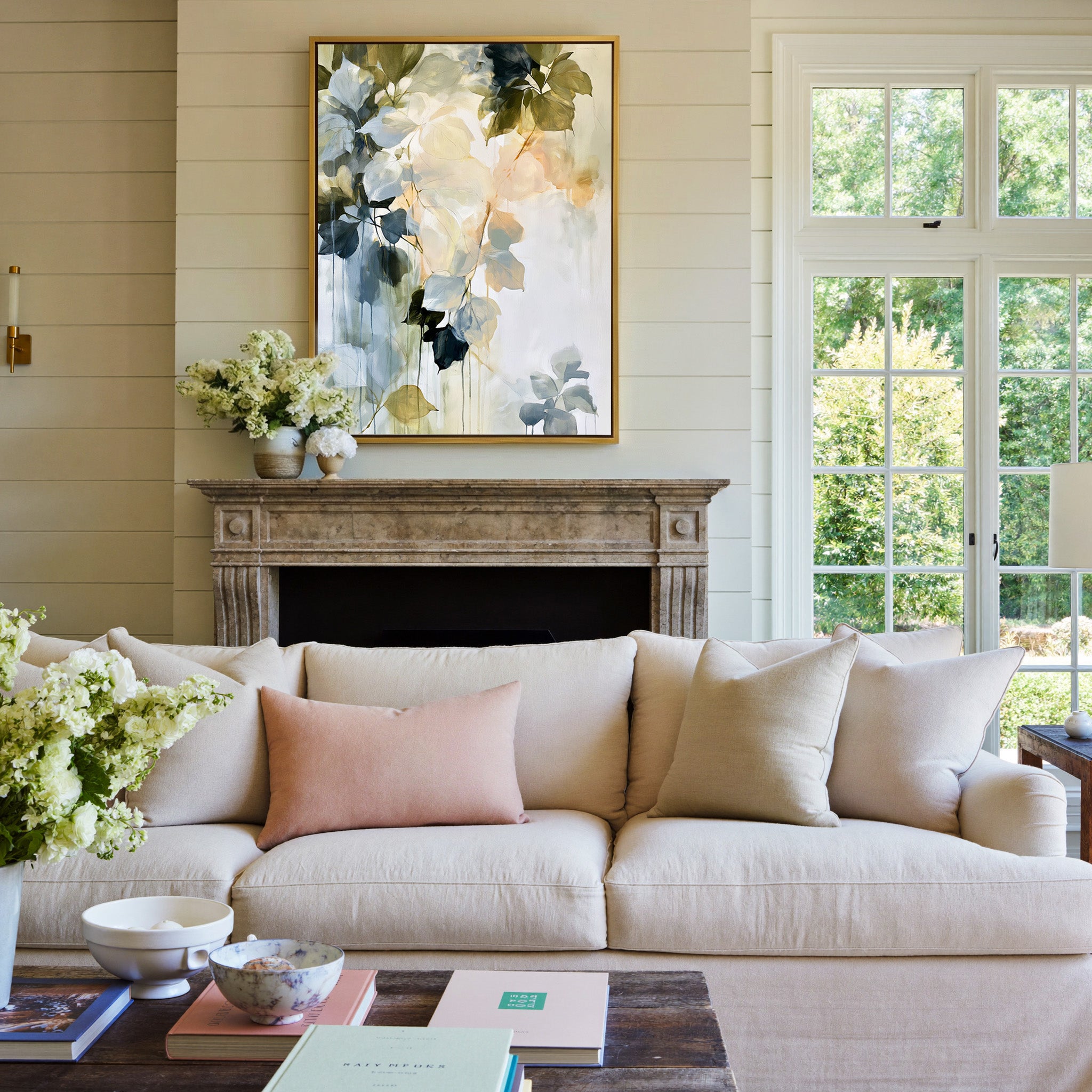 soft blue, sage, cream, and peach leaf forms canvas wall art in a gold frame above a mantel