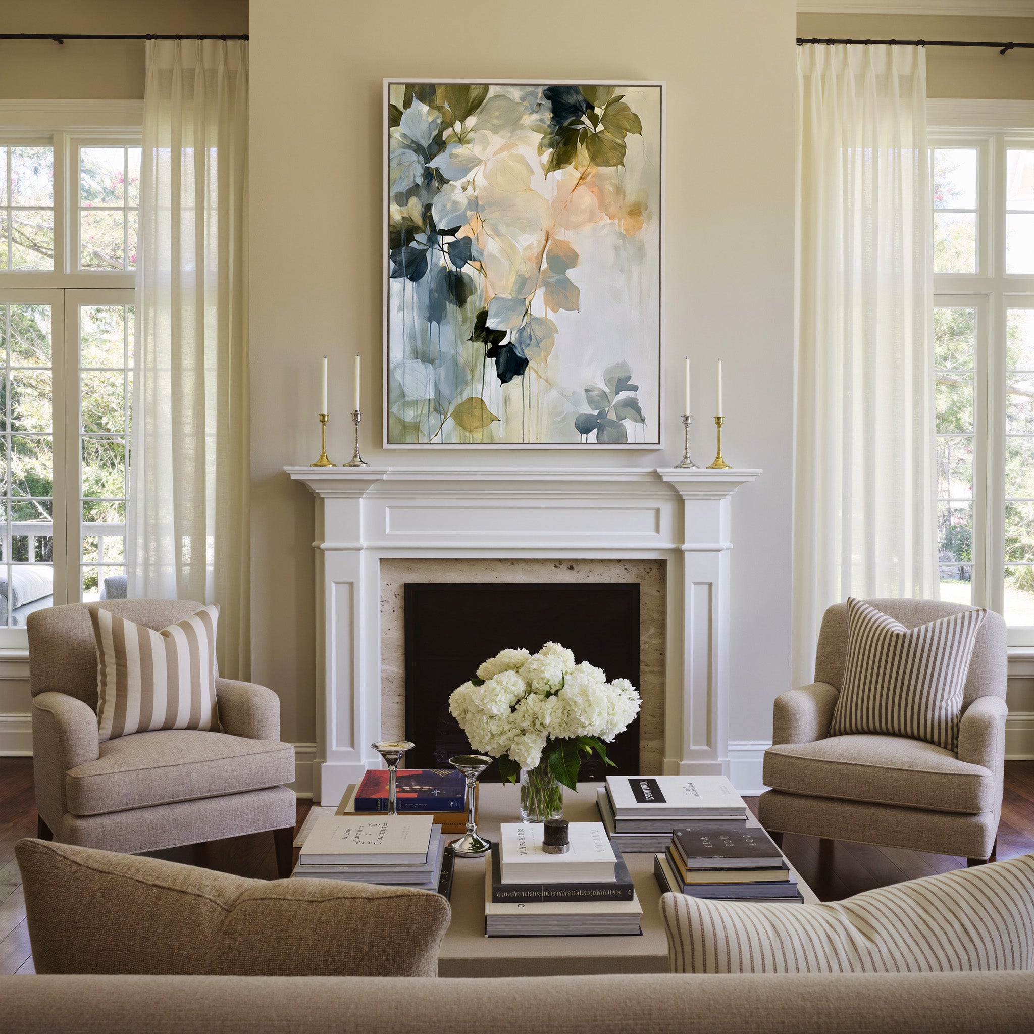 soft blue, sage, cream, and peach leaf forms canvas wall art in a white frame above a mantel