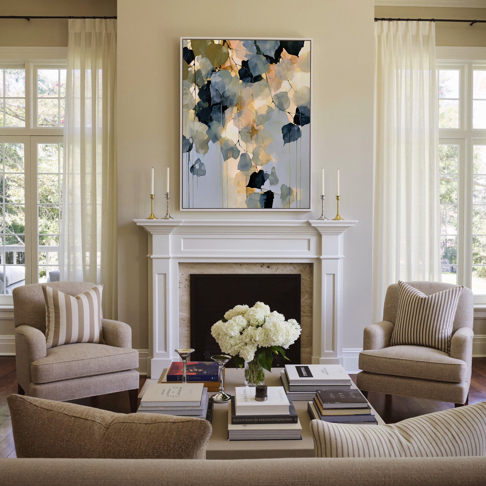 soft blue gray and gold abstract with hanging canvas wall art in a white frame above a mantel