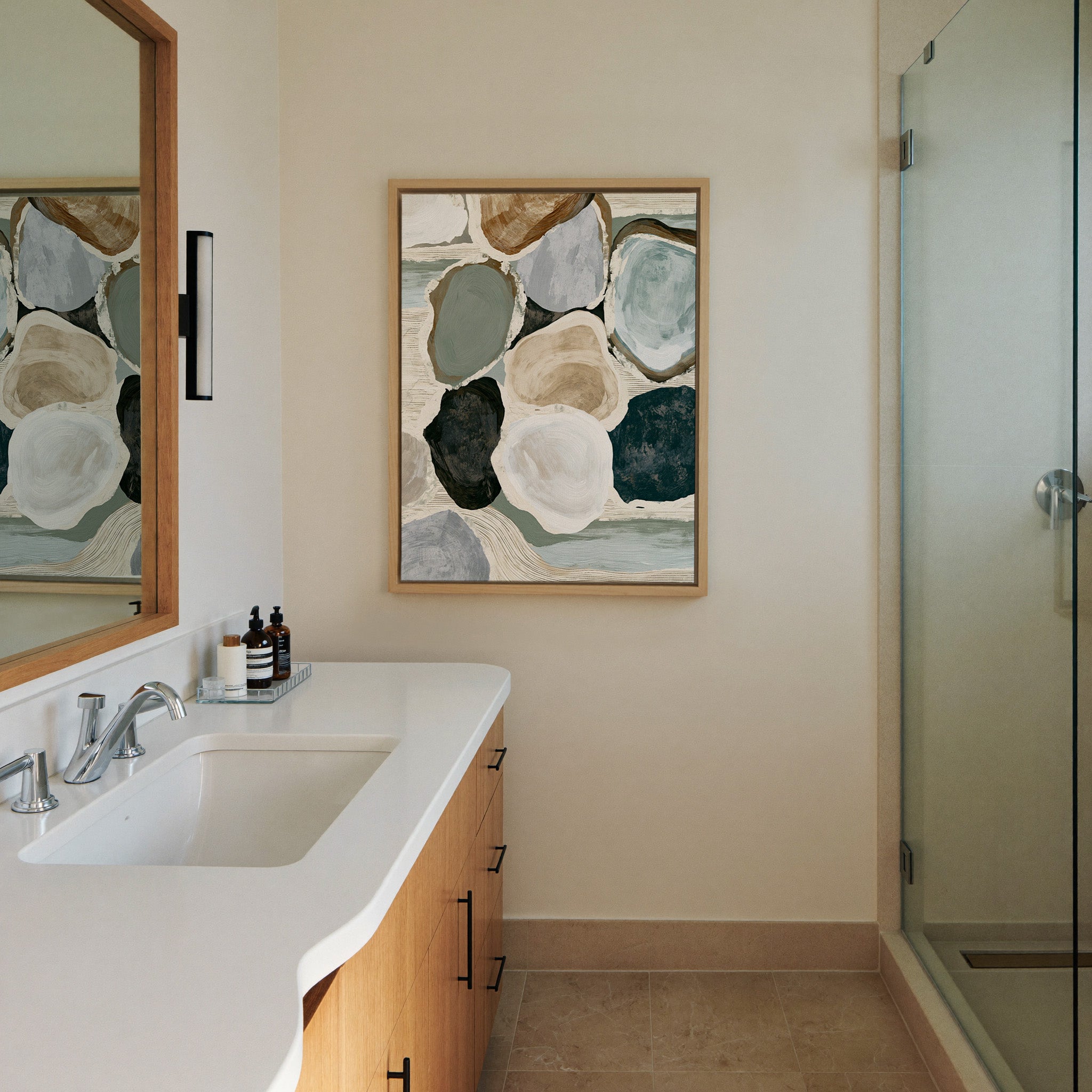 muted coastal abstract with canvas wall art in a natural wood frame in a styled room setting