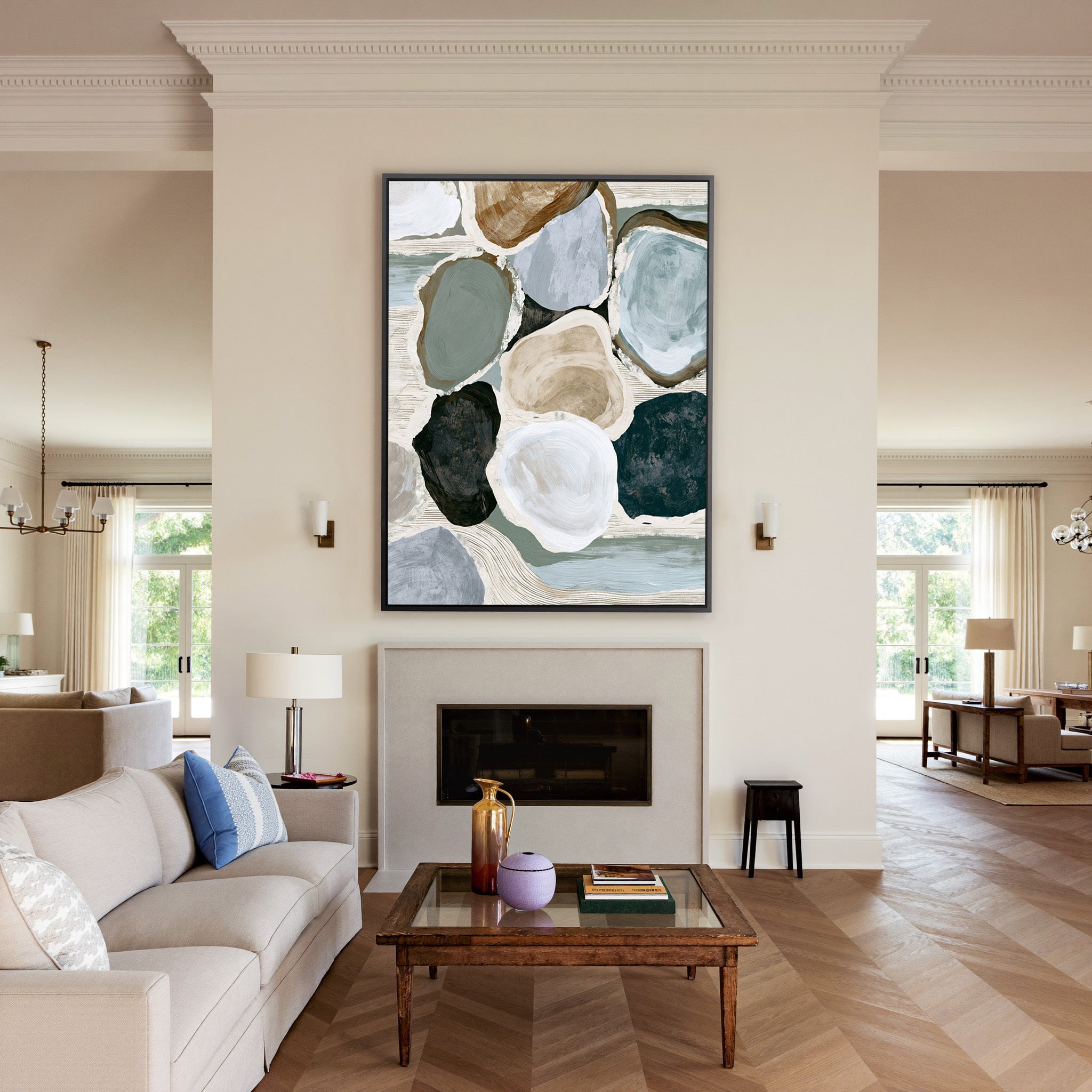 muted coastal abstract with oyster shell shapes canvas wall art in a black frame above a mantel