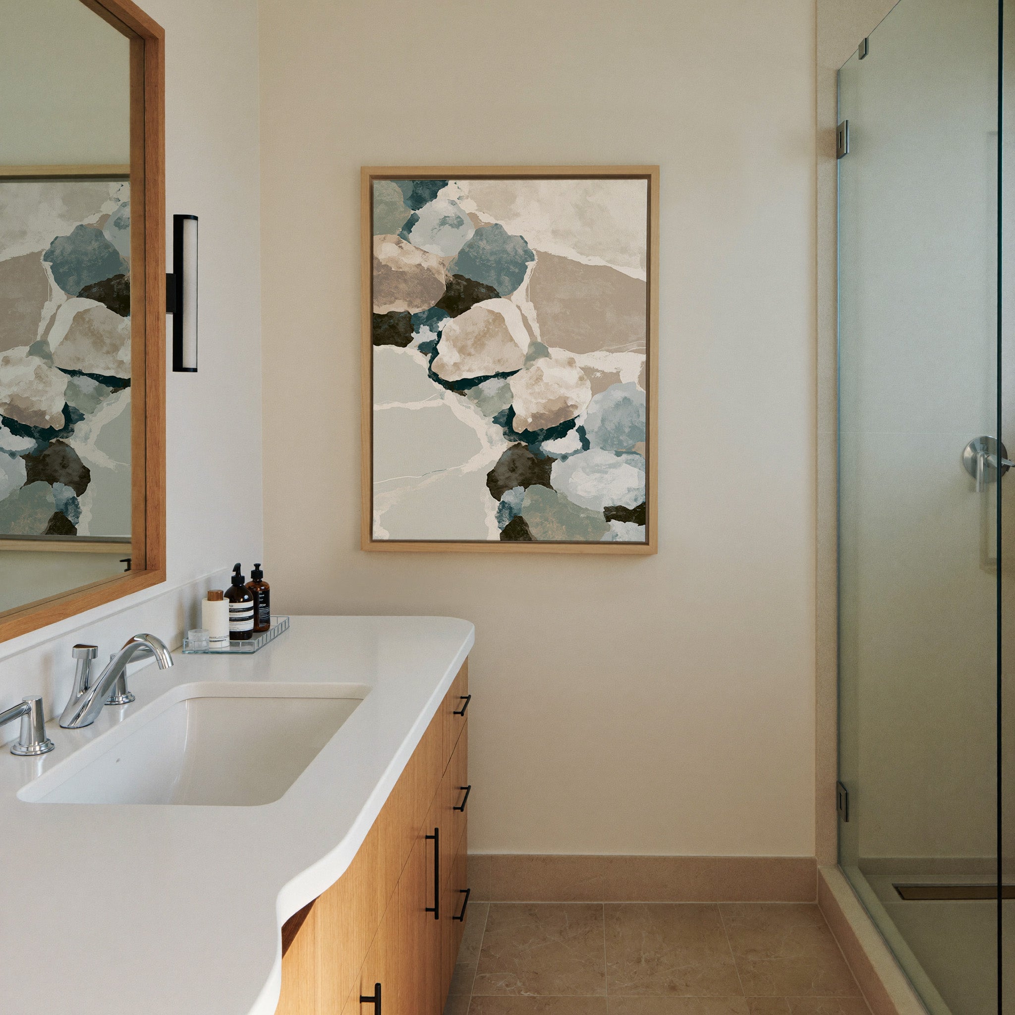 muted coastal abstract with canvas wall art in a natural wood frame in a styled room setting
