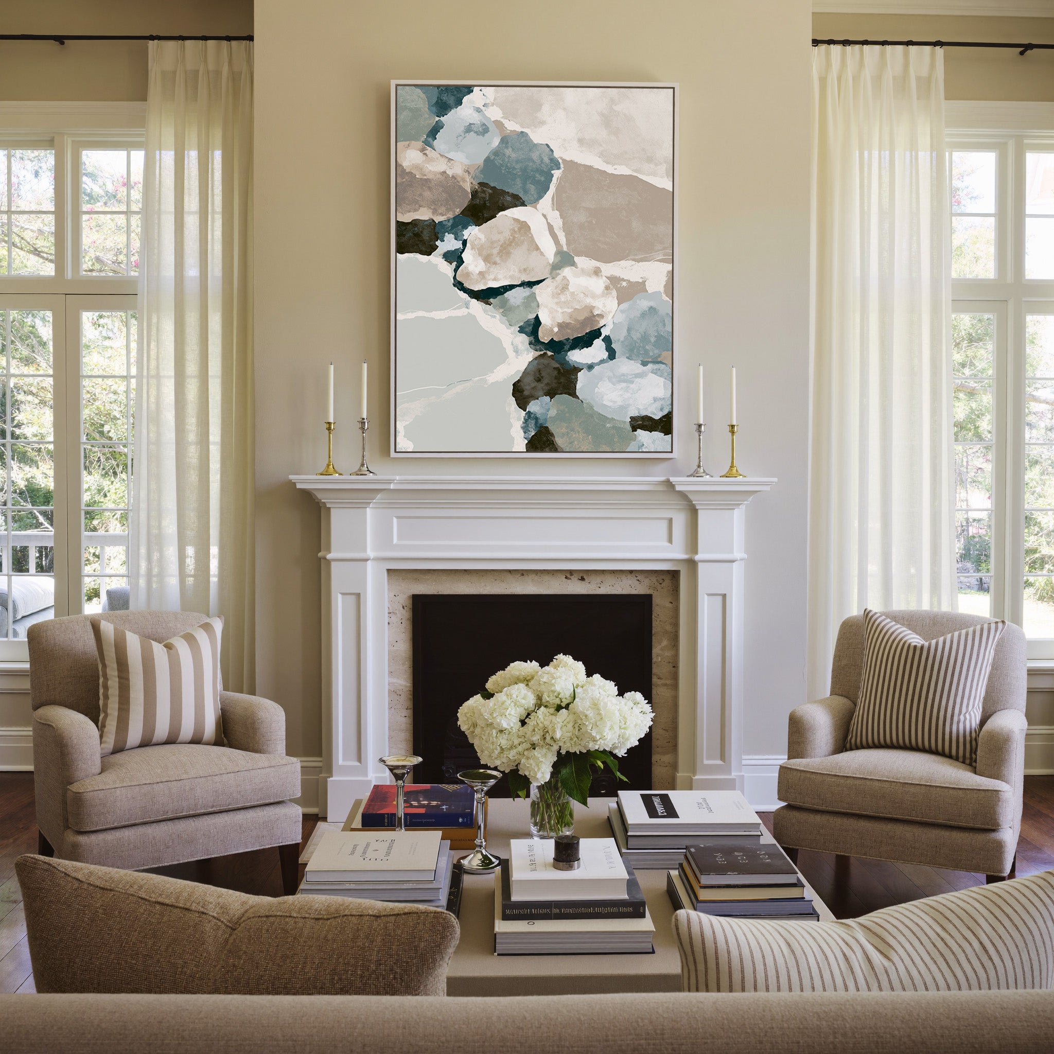 muted coastal abstract with oyster shell shapes canvas wall art in a white frame above a mantel
