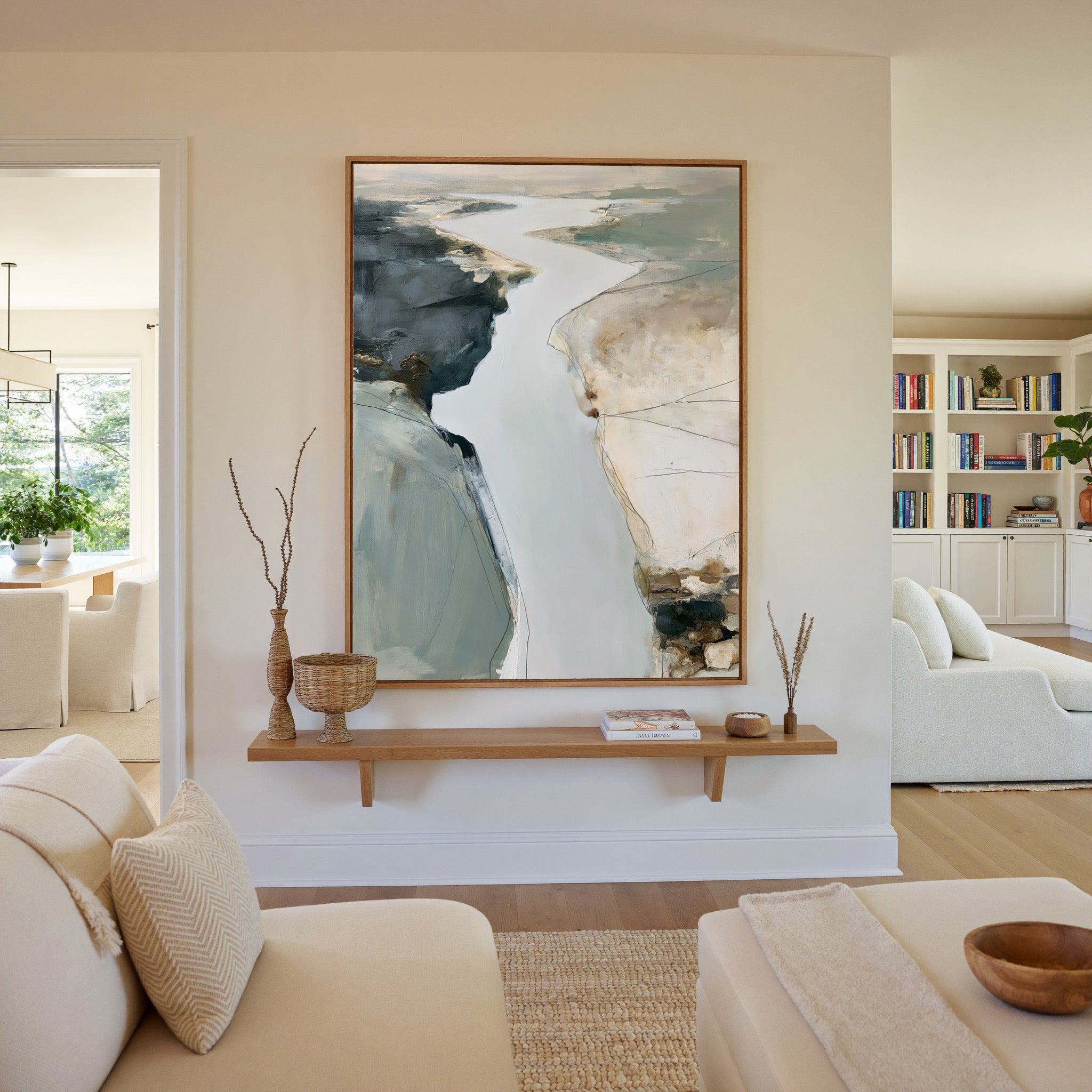 pale coastal channel abstract with slate, sand, canvas wall art in an oak frame in a living room