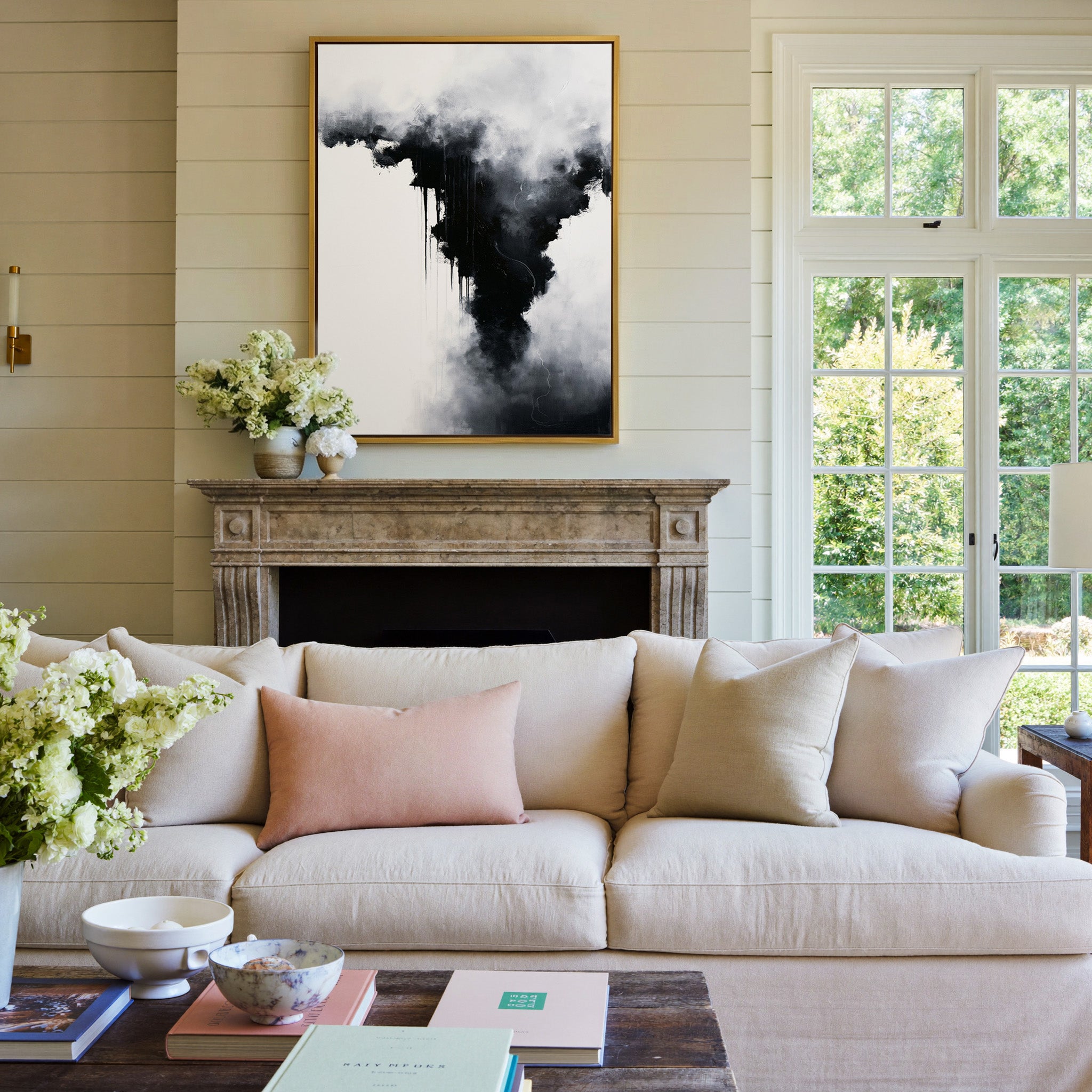 black and white abstract with smoky gray clouds canvas wall art in a gold frame above a mantel