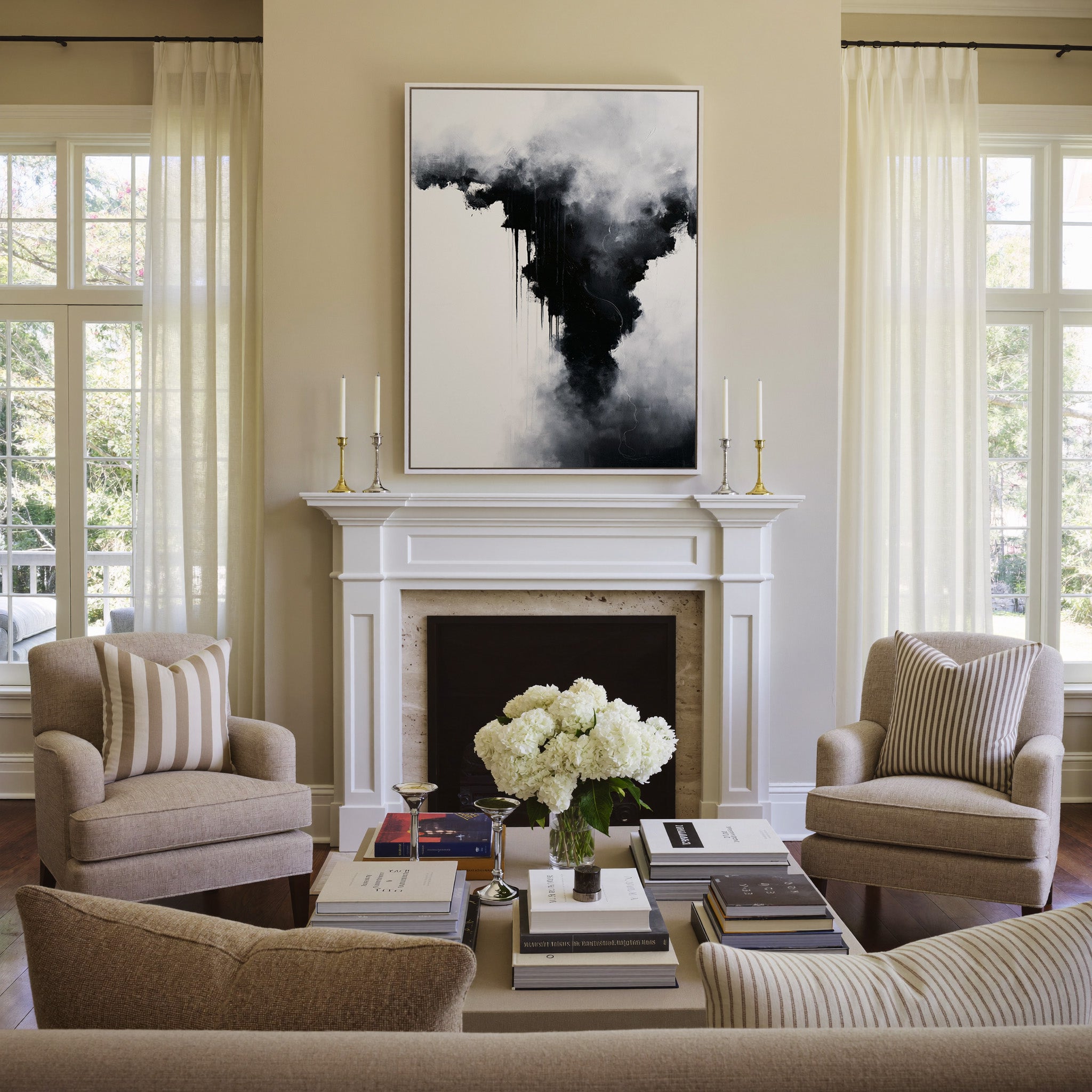 black and white abstract with smoky gray clouds canvas wall art in a white frame above a mantel