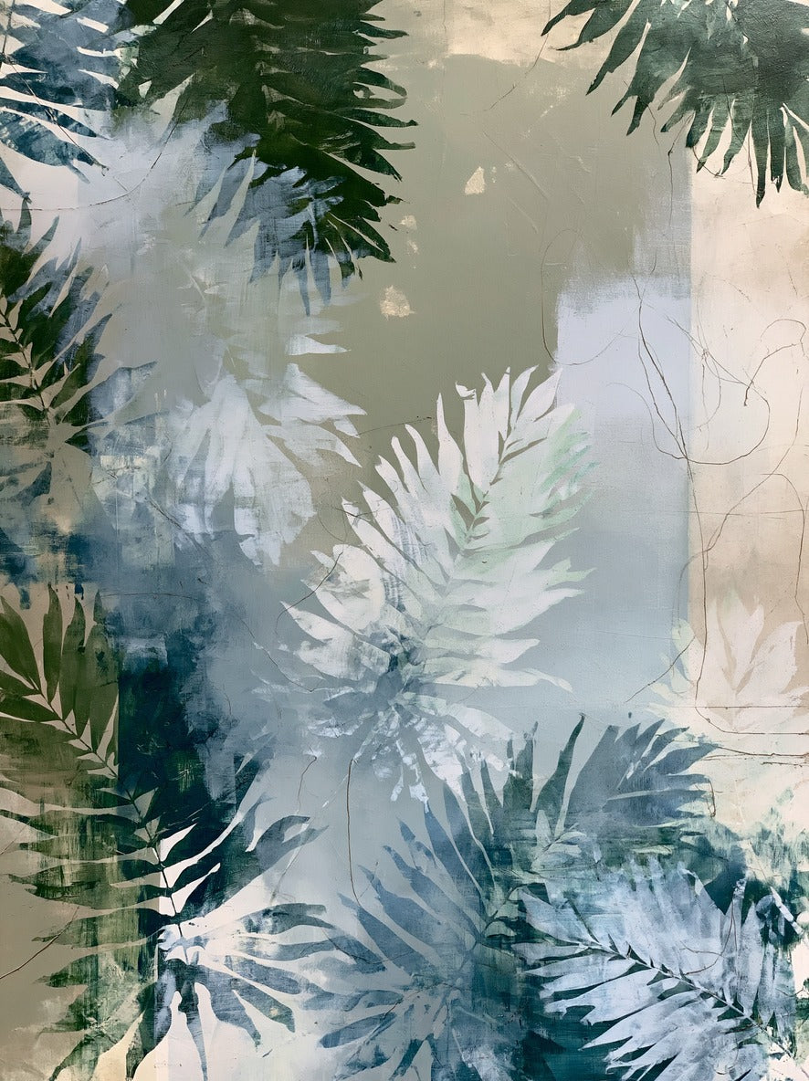 Layered fern leaves in sage, blue gray, and deep green framing a pale center