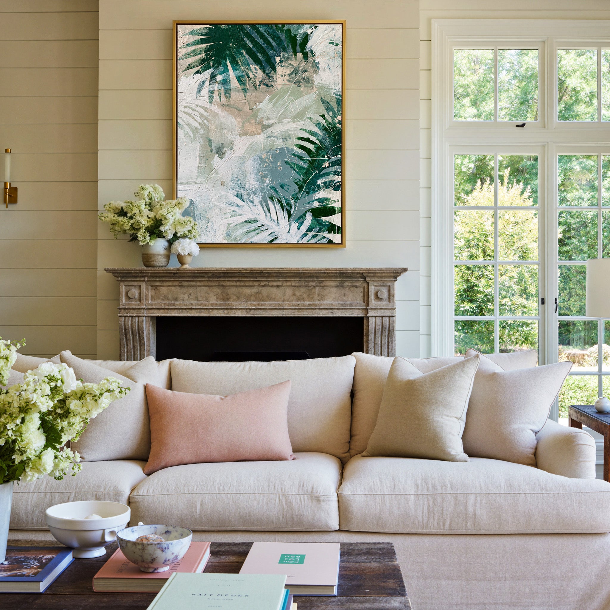 layered fern leaves in deep green, sage, white, canvas wall art in a gold frame above a mantel