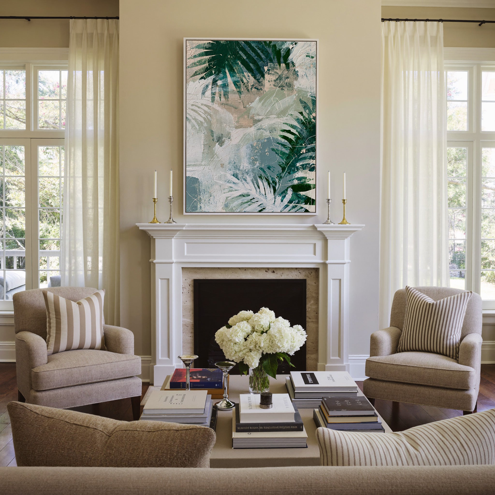 layered fern leaves in deep green, sage, white, canvas wall art in a white frame above a mantel