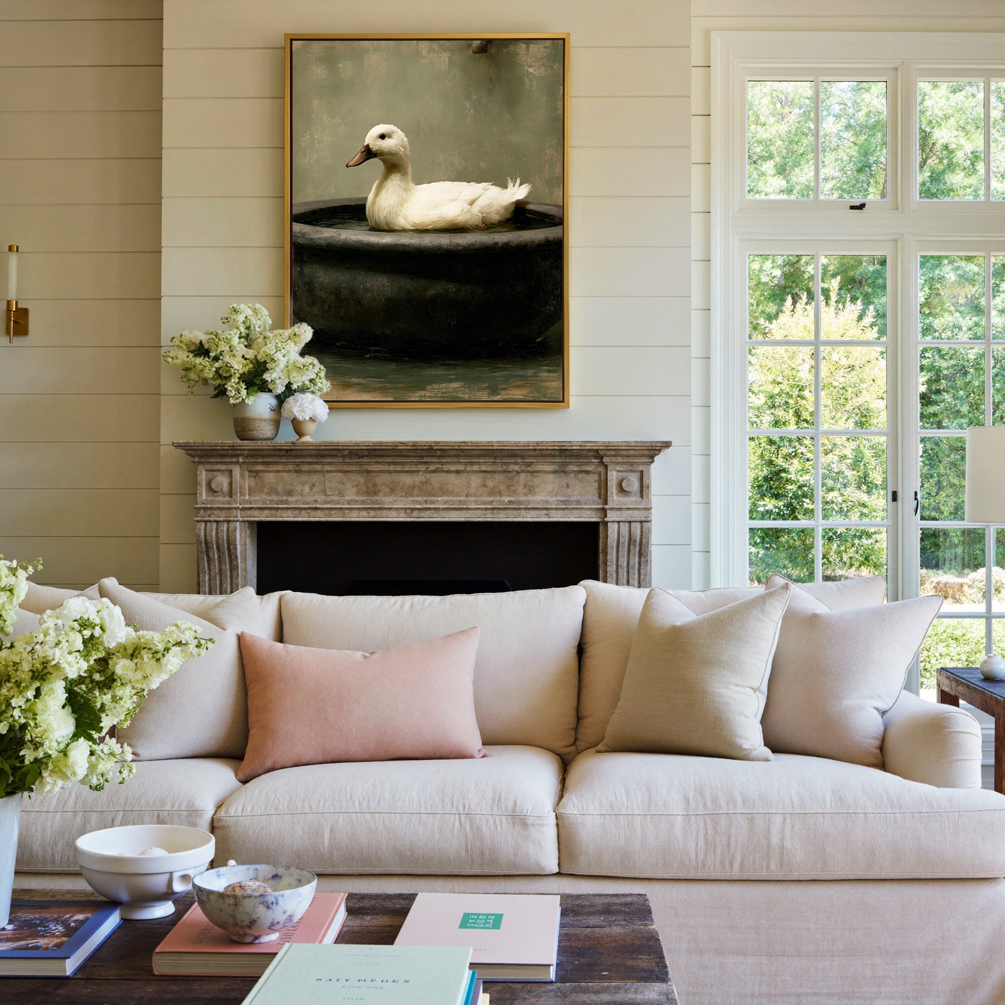 small white duck in a dark basin canvas wall art in a gold frame above a mantel