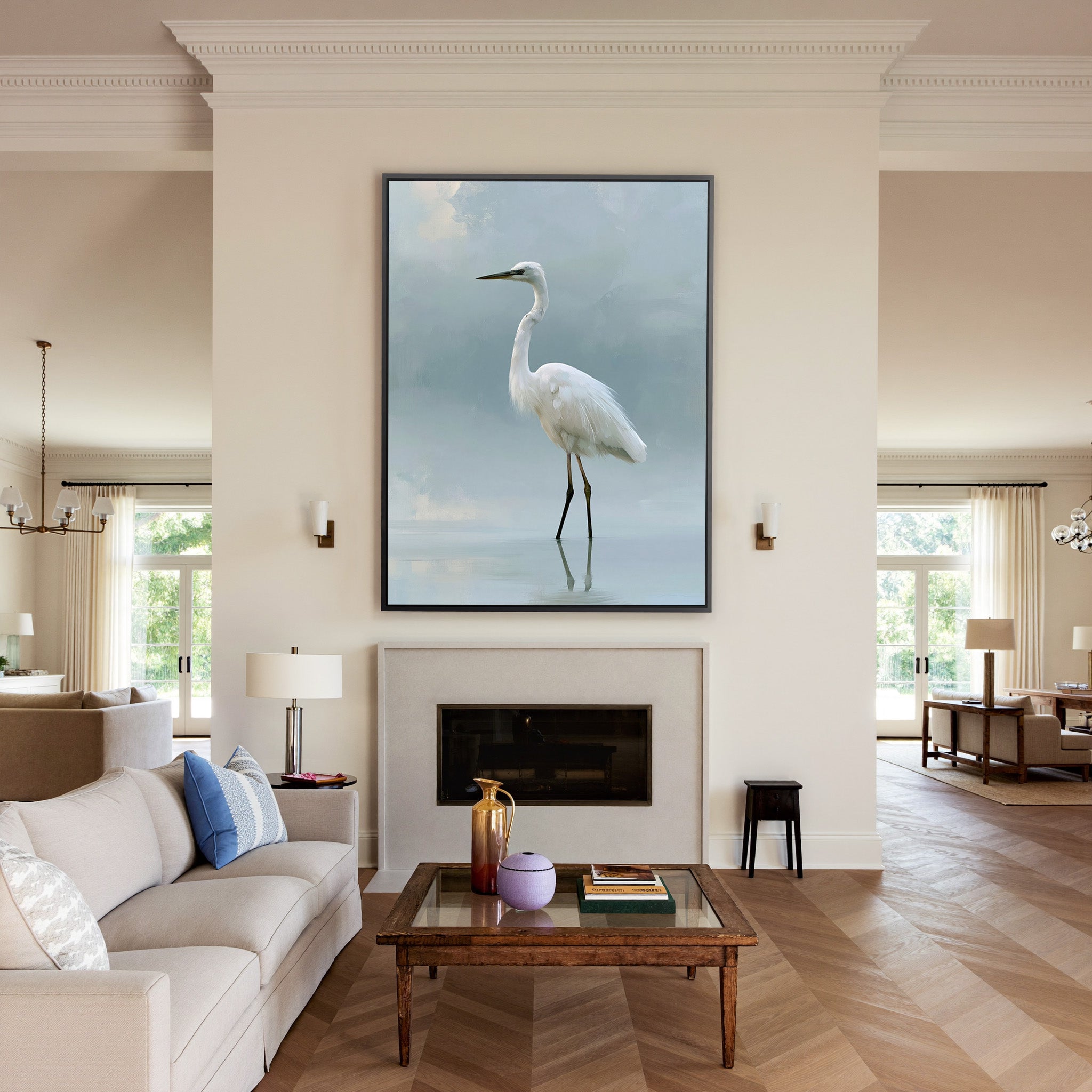 white heron standing in pale reflective water canvas wall art in a black frame above a mantel