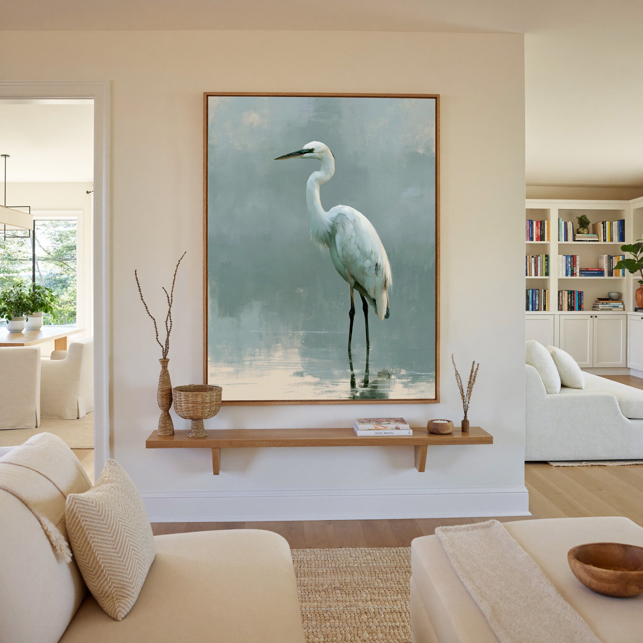 white heron in pale reflective water canvas wall art in an oak frame in a living room