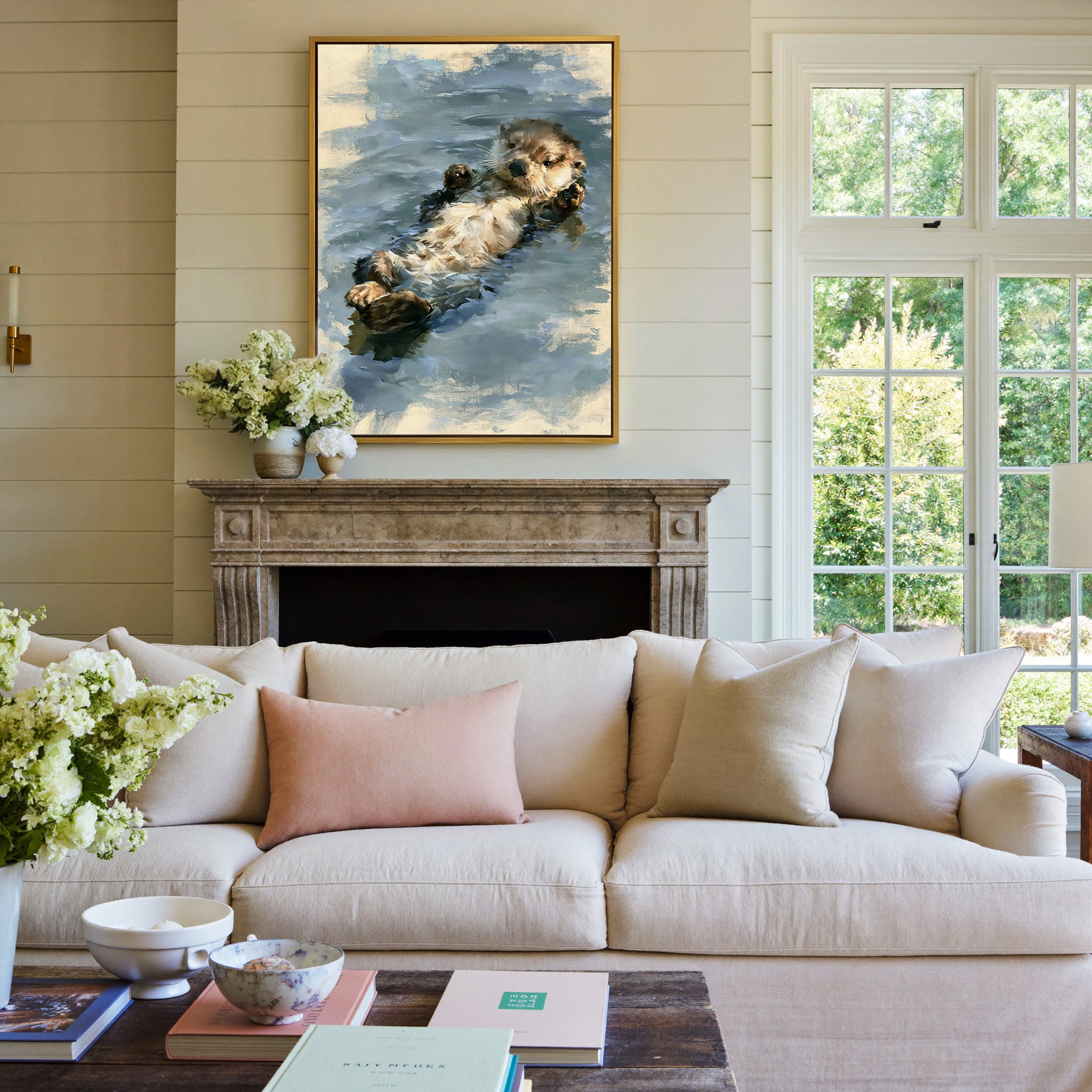 small otter floating on its back in soft grey canvas wall art in a gold frame above a mantel