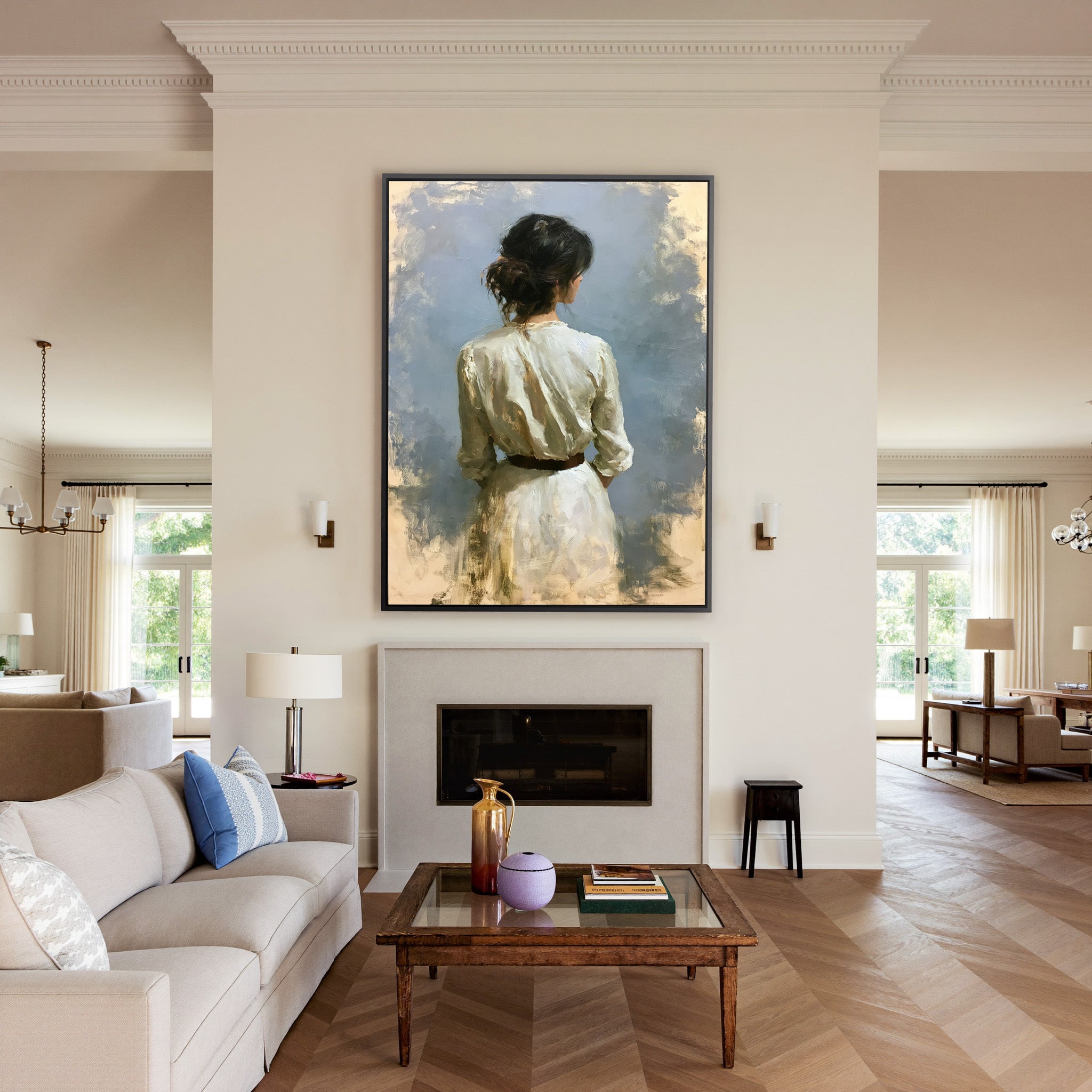 rear view woman in a white dress against a soft canvas wall art in a black frame above a mantel
