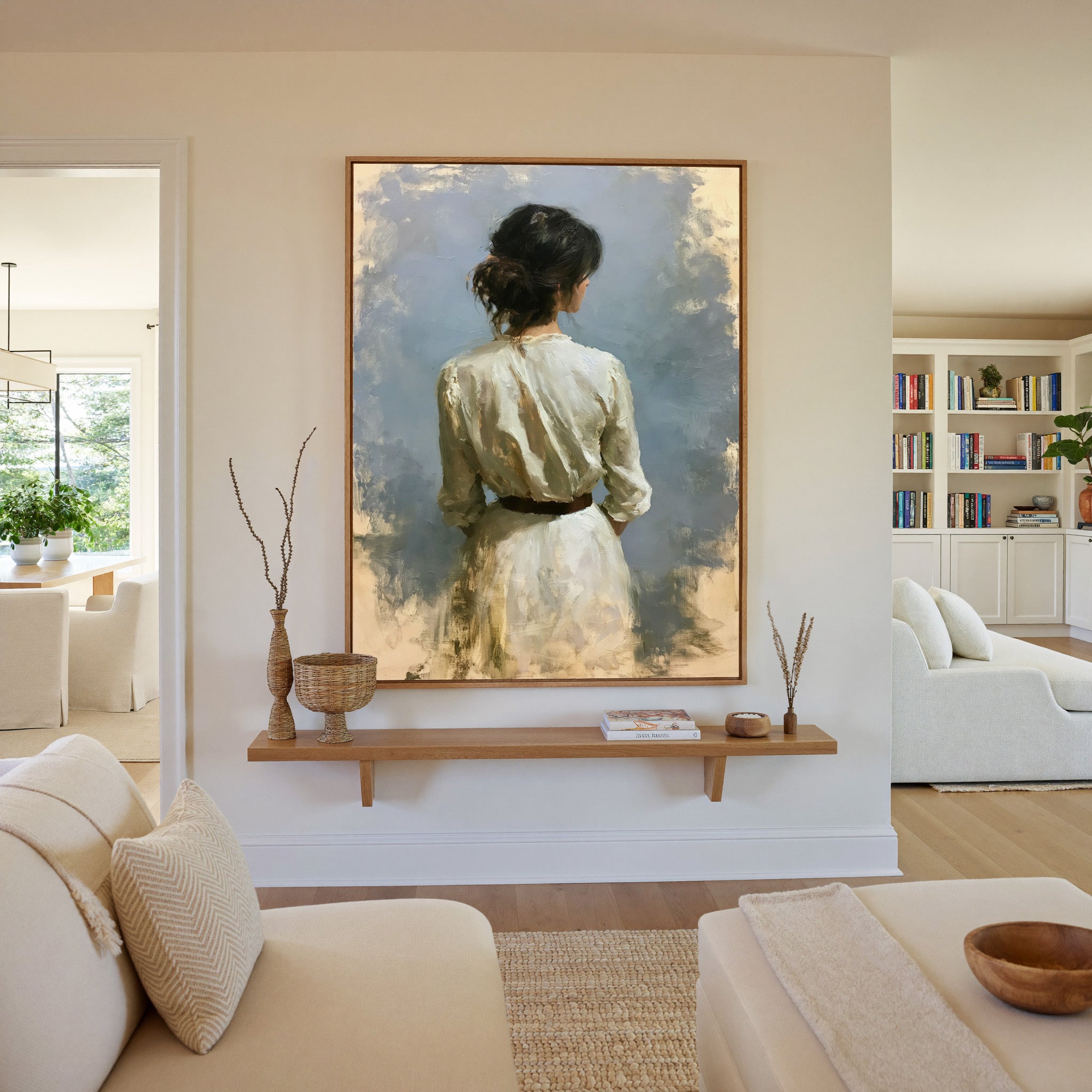 rear view woman in a white dress against a soft canvas wall art in an oak frame in a living room
