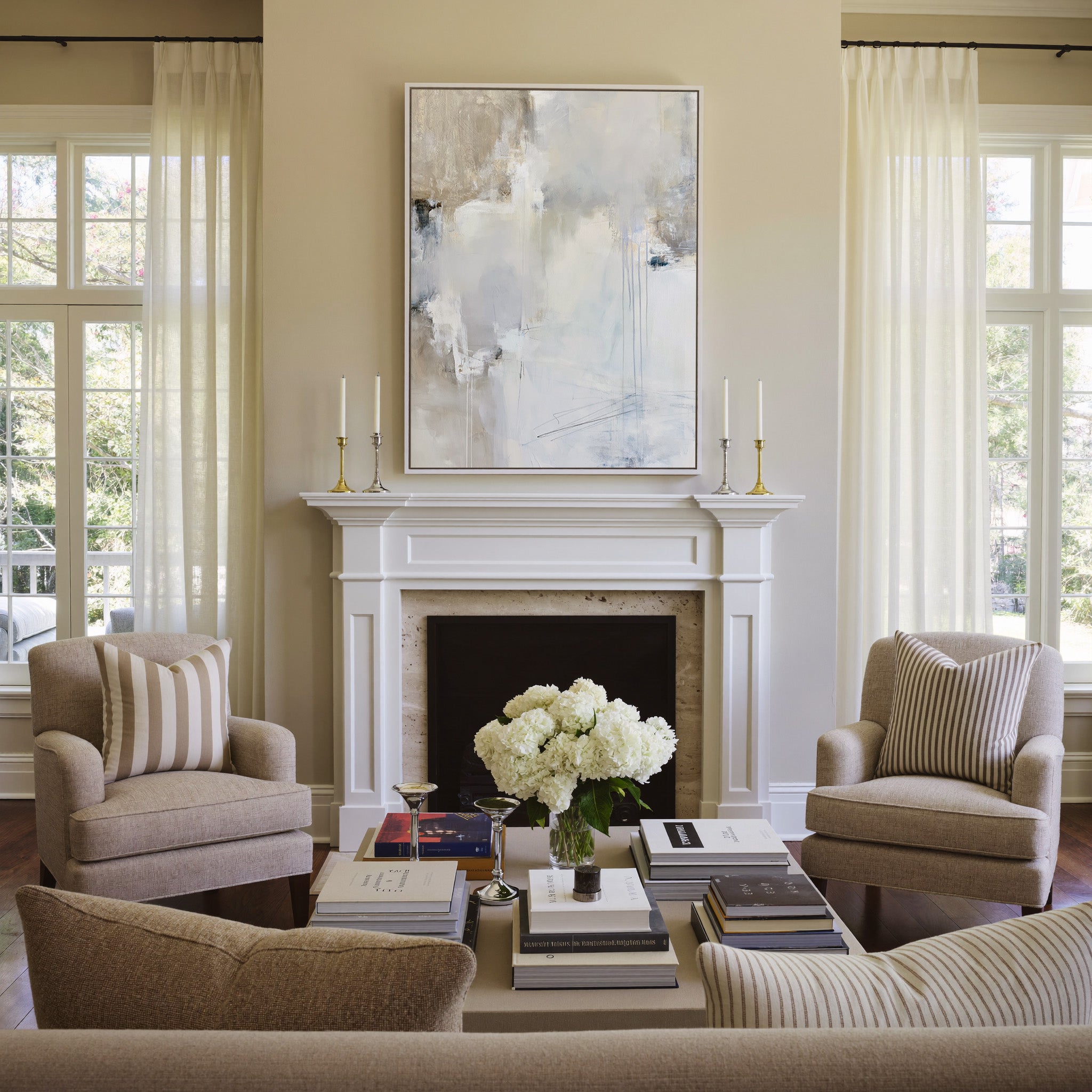 soft white and beige abstract with pale blue canvas wall art in a white frame above a mantel