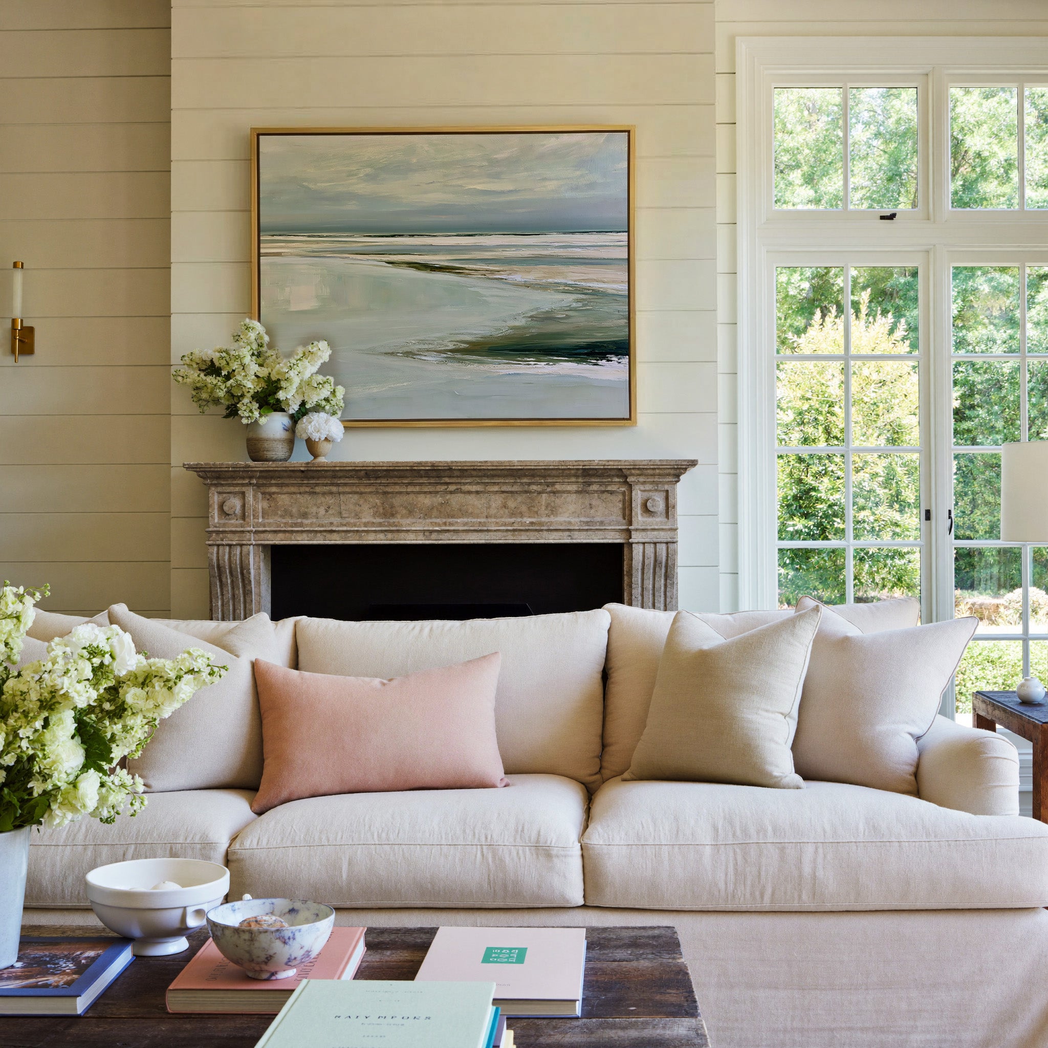 pale reflective shoreline with low horizontal canvas wall art in a gold frame above a mantel