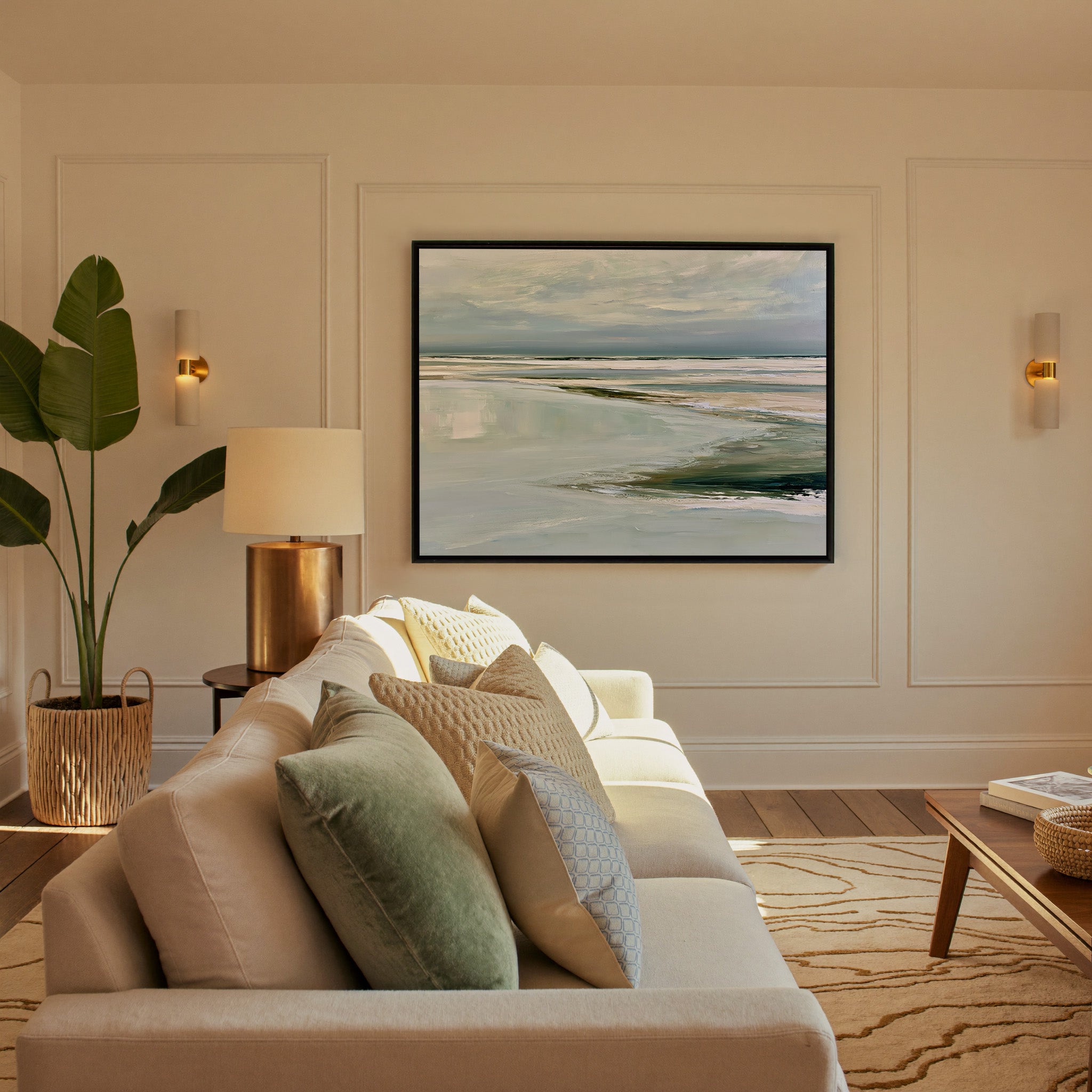 pale reflective shoreline with low horizontal canvas wall art in a black frame in a styled room setting