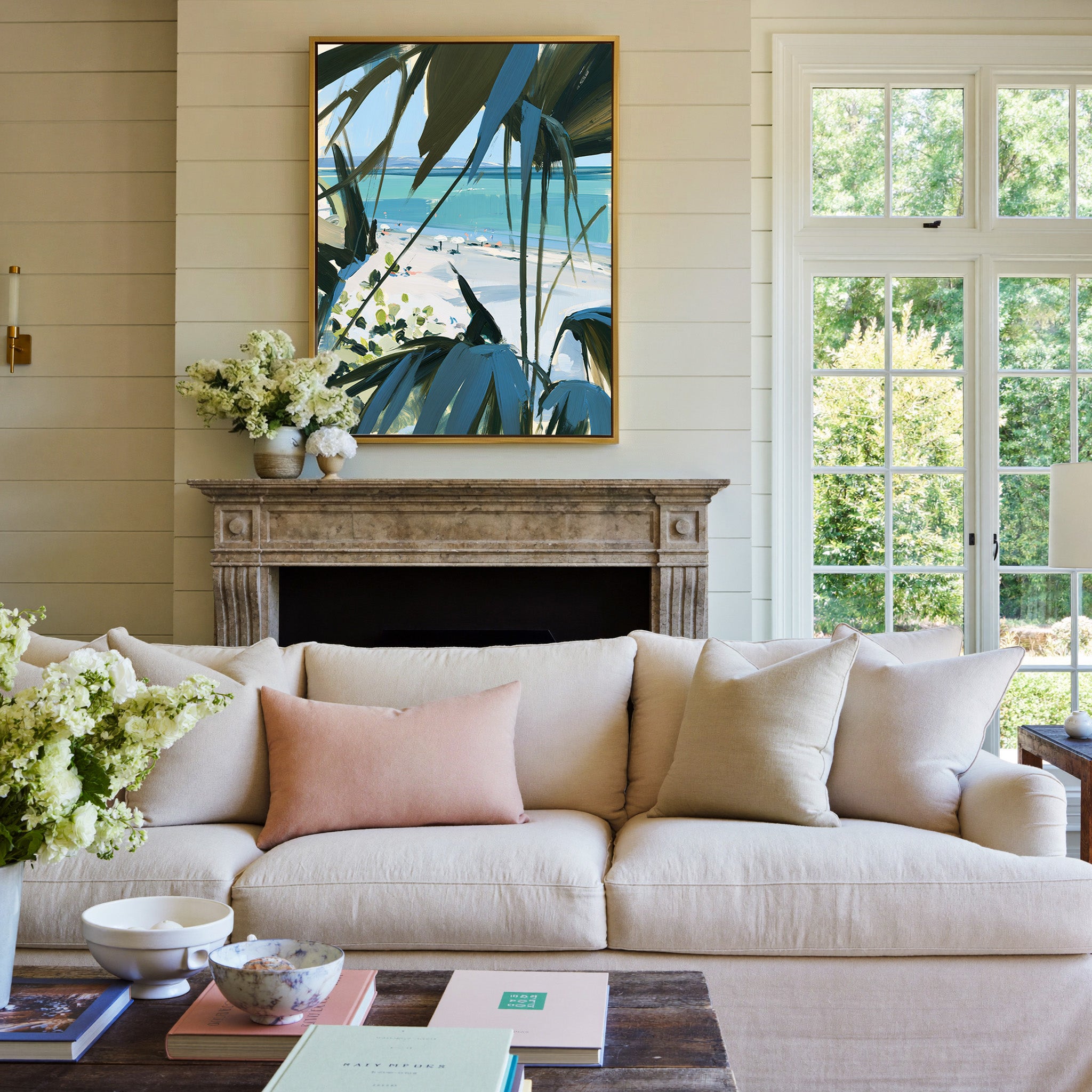 beach view through dark palm fronds canvas wall art in a gold frame above a mantel