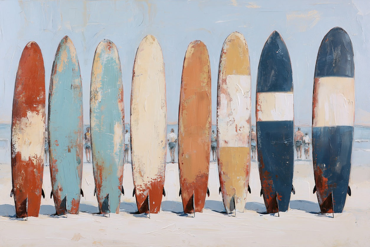 Row of colorful surfboards upright on pale sand with a light blue sky behind