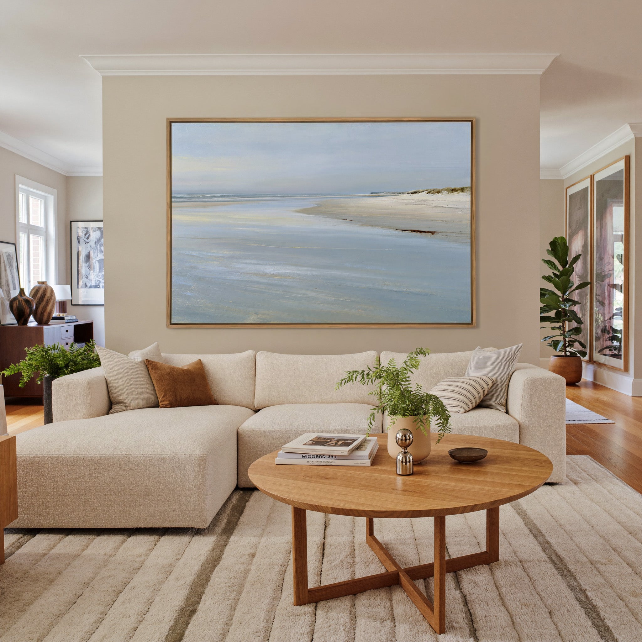 pale shoreline with wet sand and a low horizon canvas wall art in an oak frame in a living room