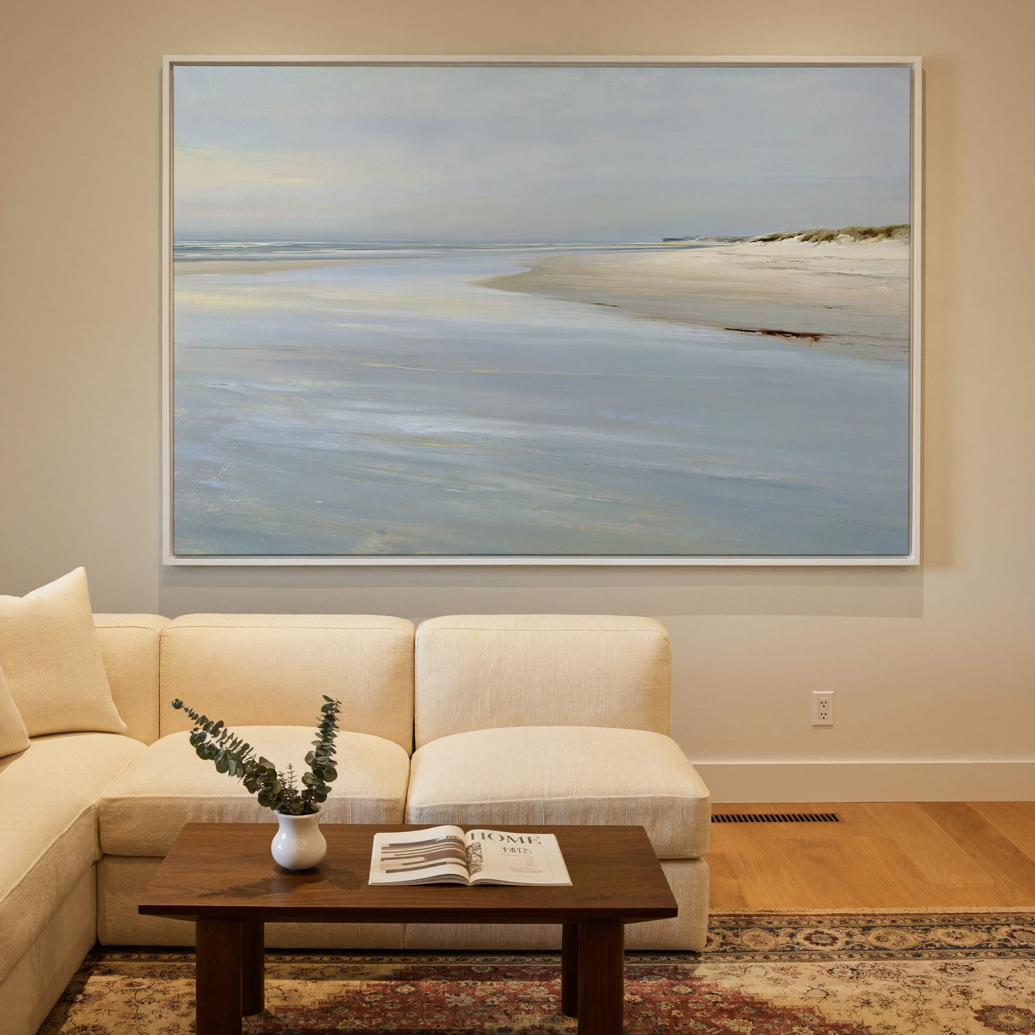 pale shoreline with wet sand and a low horizon canvas wall art in a white frame in a styled room setting