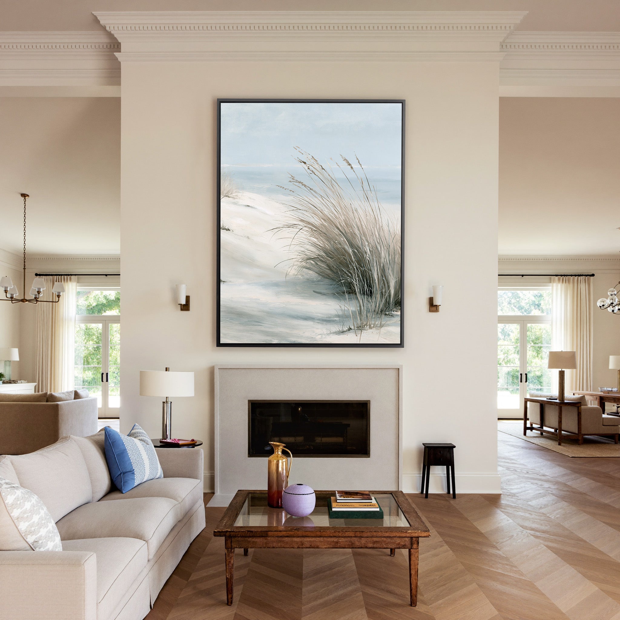 pale dune grass over soft blue water canvas wall art in a black frame above a mantel